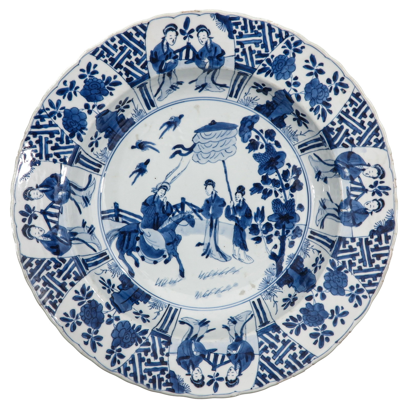 A Blue and White Charger: Fullly decorated with scenes of ladies in a garden, Kangxi Mark and Period, 34 cm in diameter, chip.