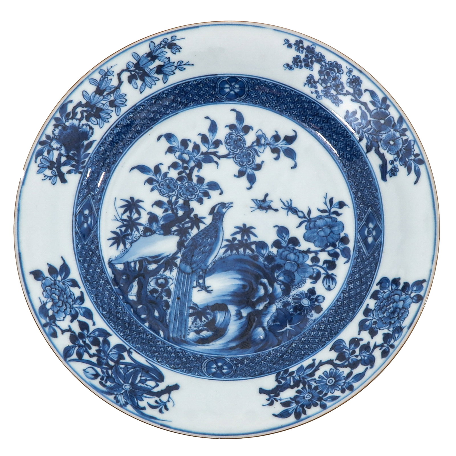 A Blue and White Plate: Decorated with a phoenix amongst flowering branches and rockwork, 23 cm in diameter, 18th Century, chip and hairline.