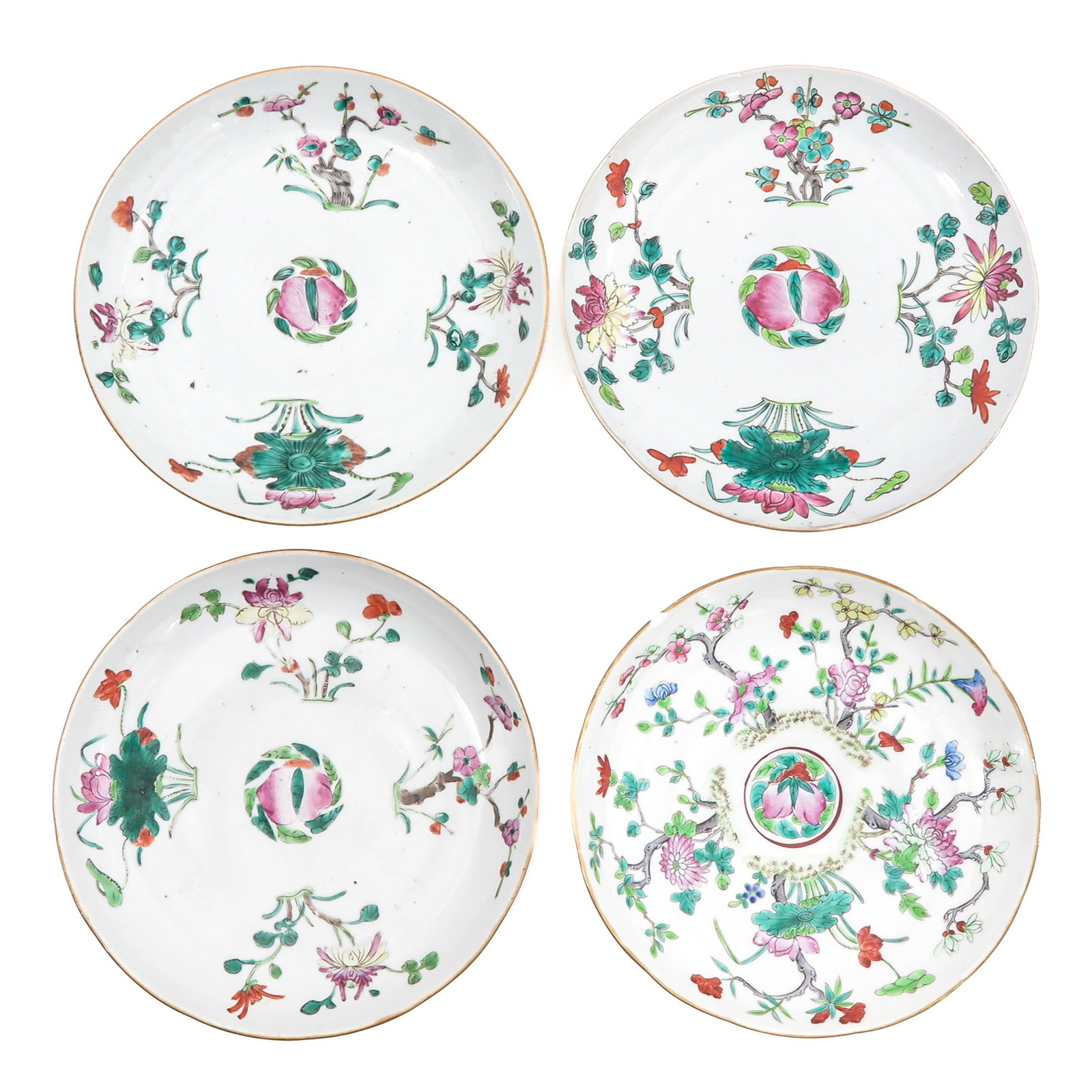 A Group of 4 Famille Rose Plates: Decorated with flowers, blossoming branches and peach motifs, 19th Century, 23 cm in diameter, chip.