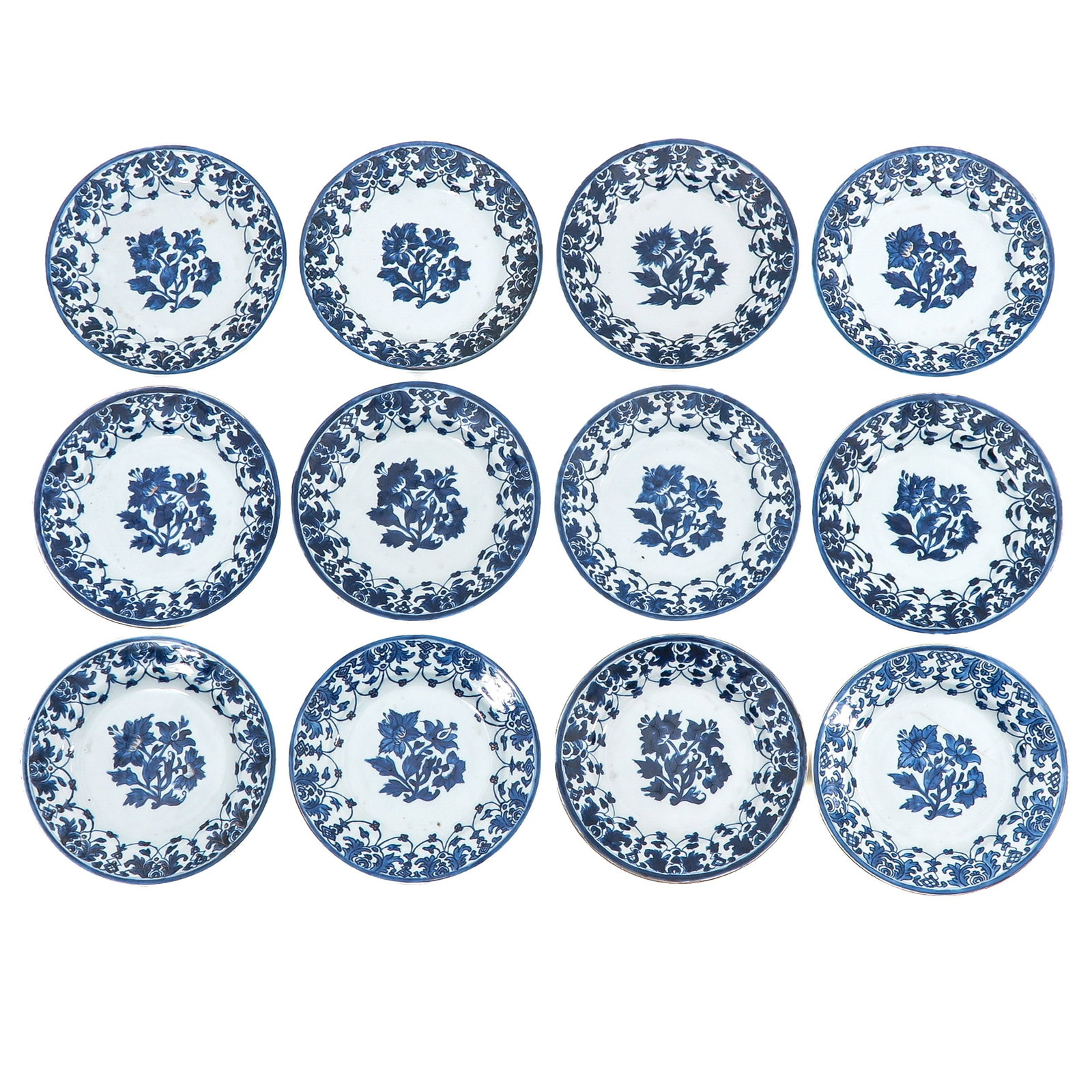 A Series of 12 Blue and White Plates: Decorated with central floral sprays within foliate borders, Qianlong Period, 23 cm in diameter, chip and hairline.