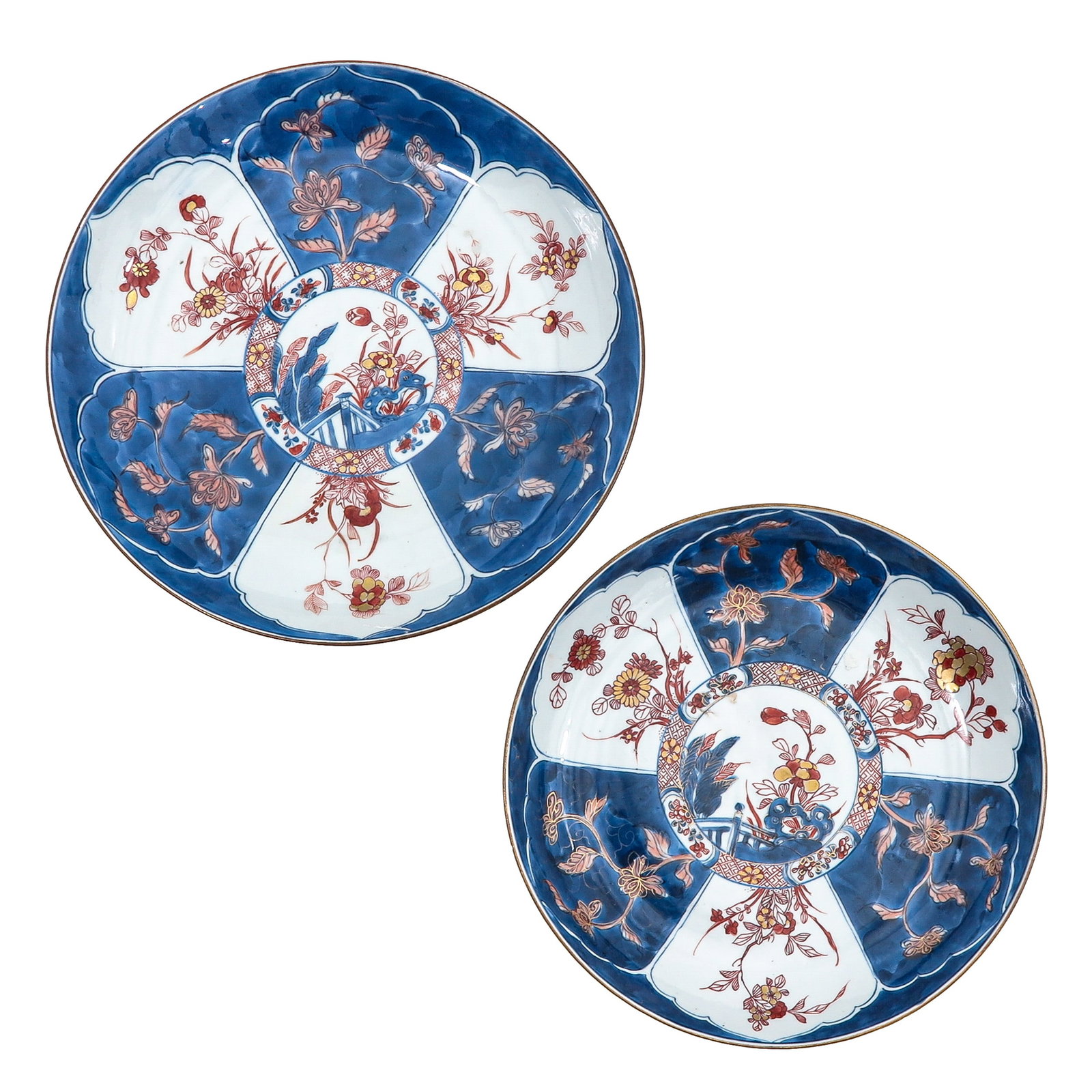 A Lot of 2 Imari Plates: Decorated with floral motifs in underglaze blue and iron red, 18th Century, largest plate is 28 cm in diameter, chip.