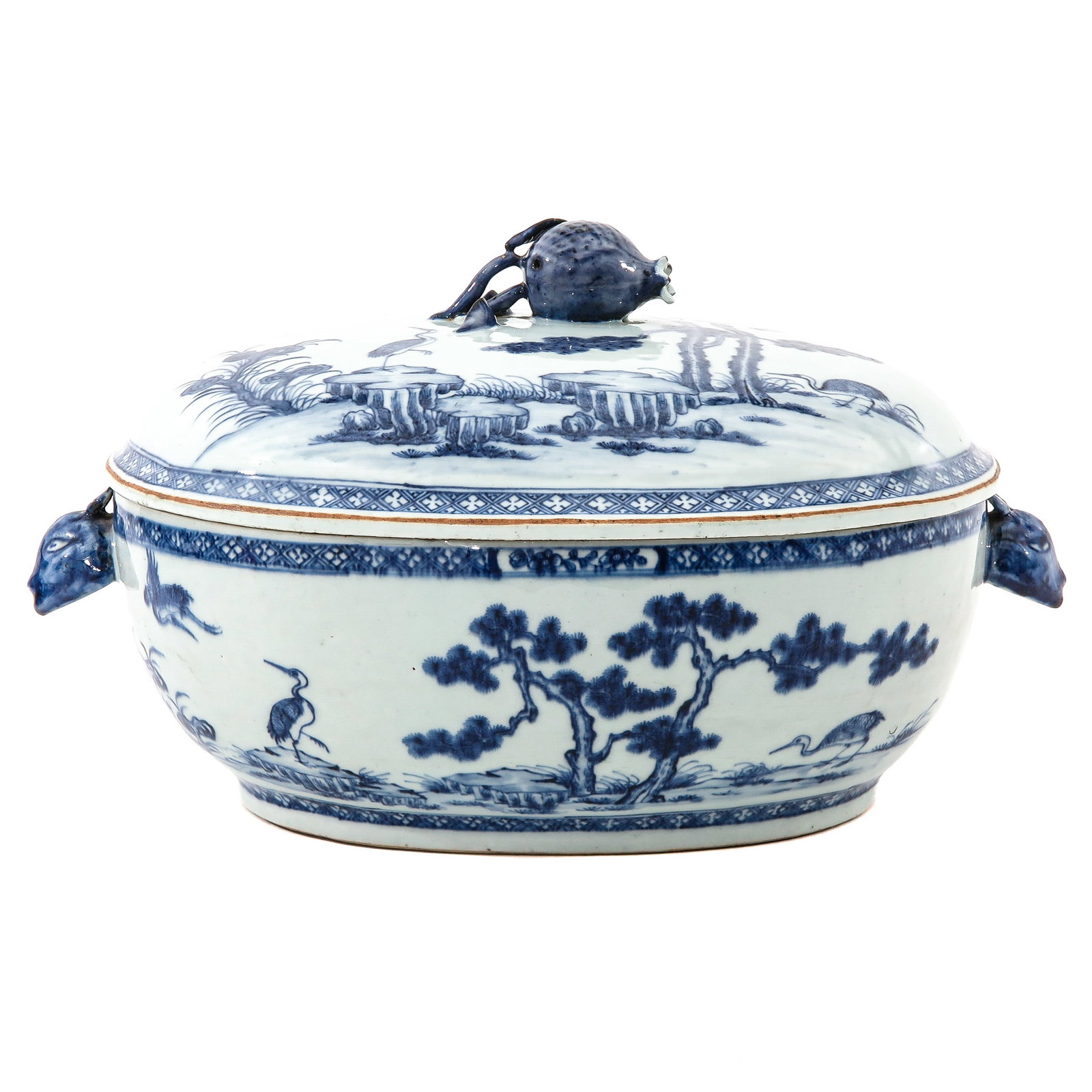 A Blue and White Tureen and Cover: Decorated with a continuous landscape with trees and birds, the cover with a fruit form finial and animal head handles, Qianlong Period, 36 cm long.