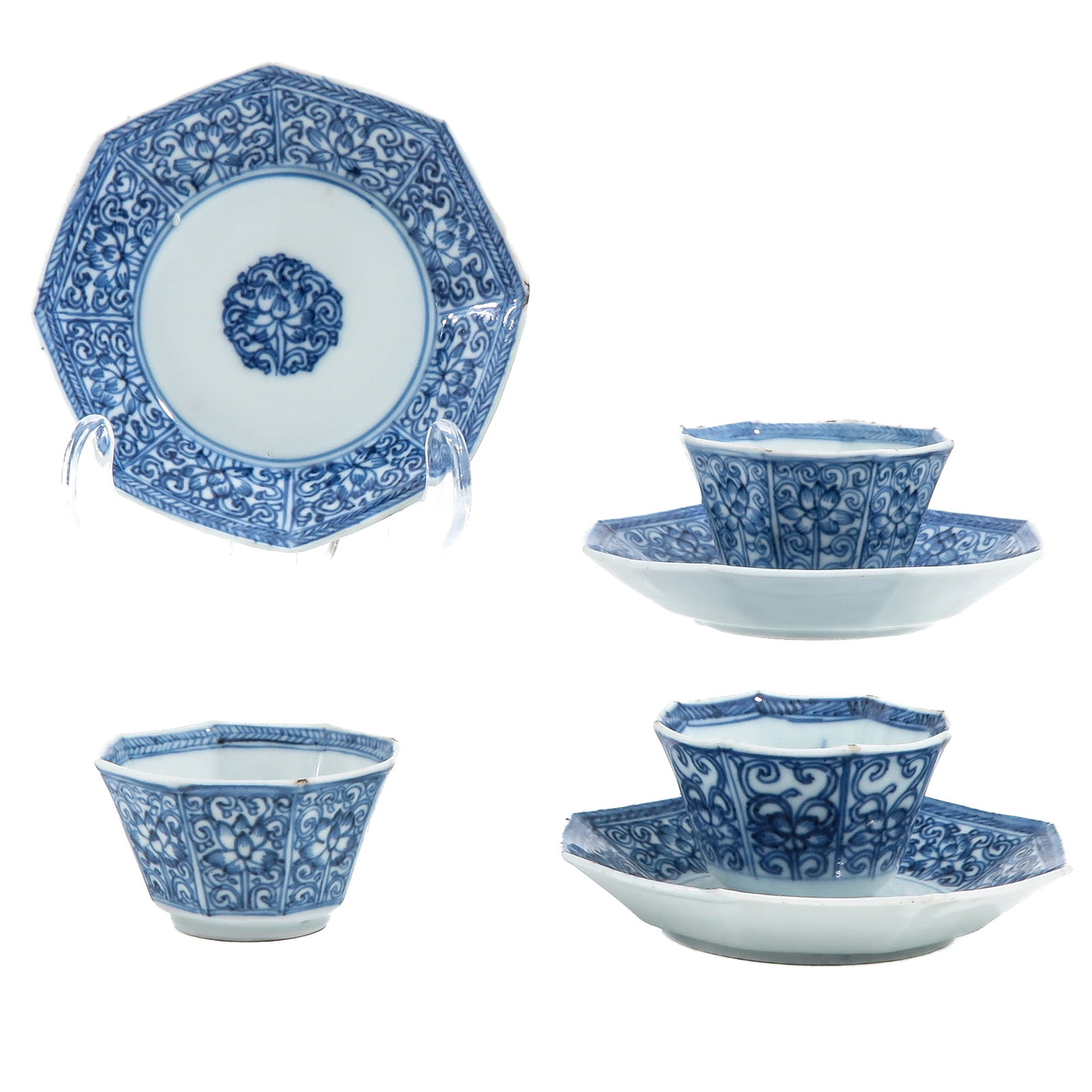 A Group of 3 Cups and Saucers: Octagonal in shape with floral scolling decor, saucers are 10 cm in diameter, 18th Century, fritting.