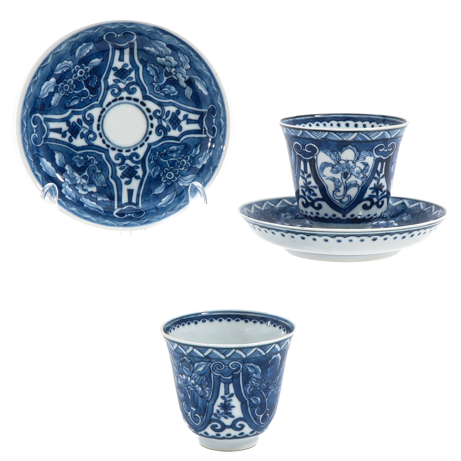 A Pair of Cups and Saucers: Decorated with floral motifs and cartouches, 18th Century, saucers are 13 cm in diameter, hairline.