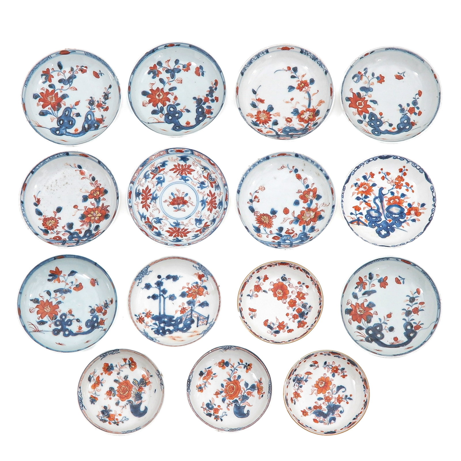 A Group of Imari Porcelain Saucers: Decorated with floral motifs in underglaze blue and iron red, 18th Century, largest saucer is 13 cm in diameter, in diverse conditions.