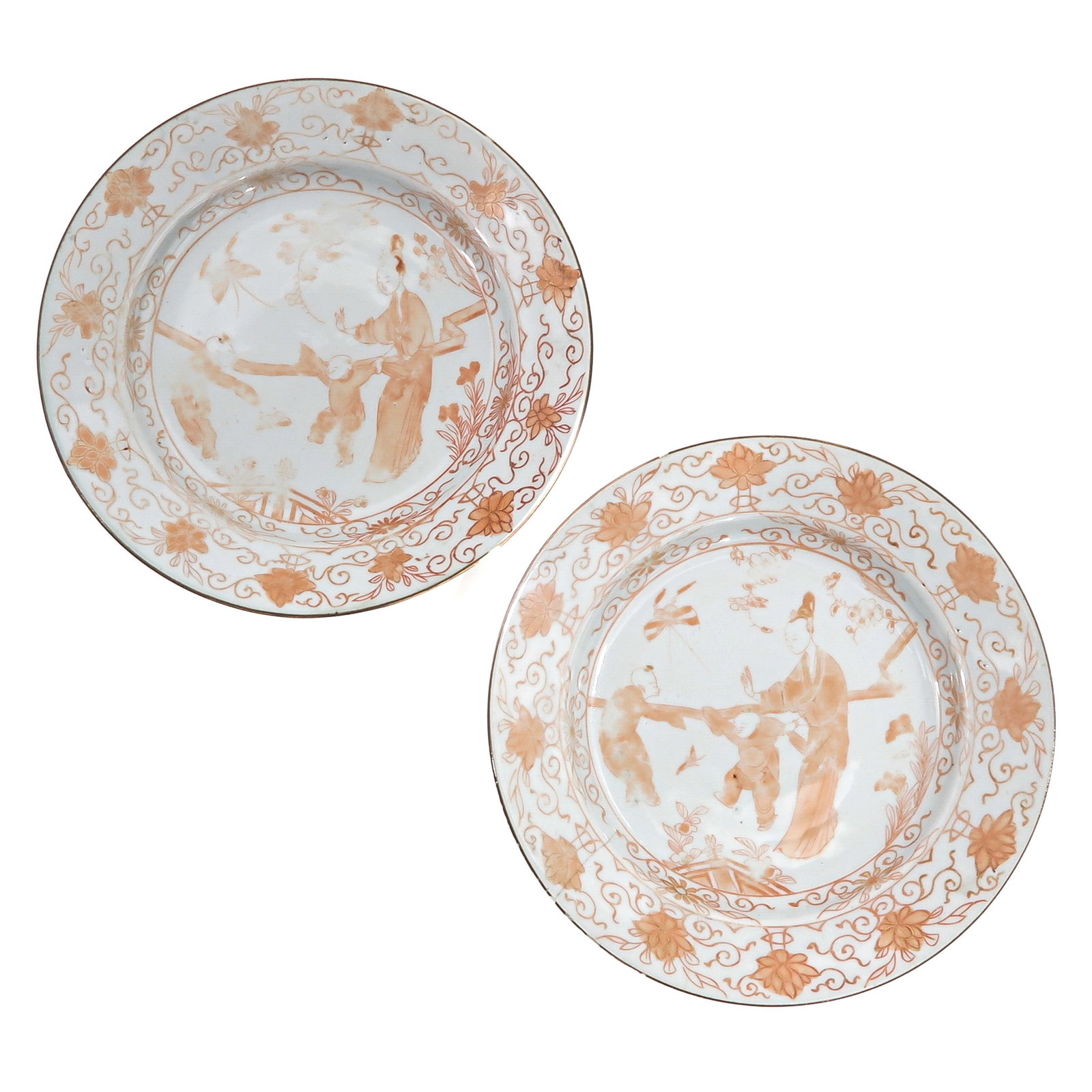 A Lot of 2 Milk and Blood Decor Plates: Depicting figures in a garden scene with scrolling floral borders, 18th Century, 21 cm in diameter, chip and hairline.