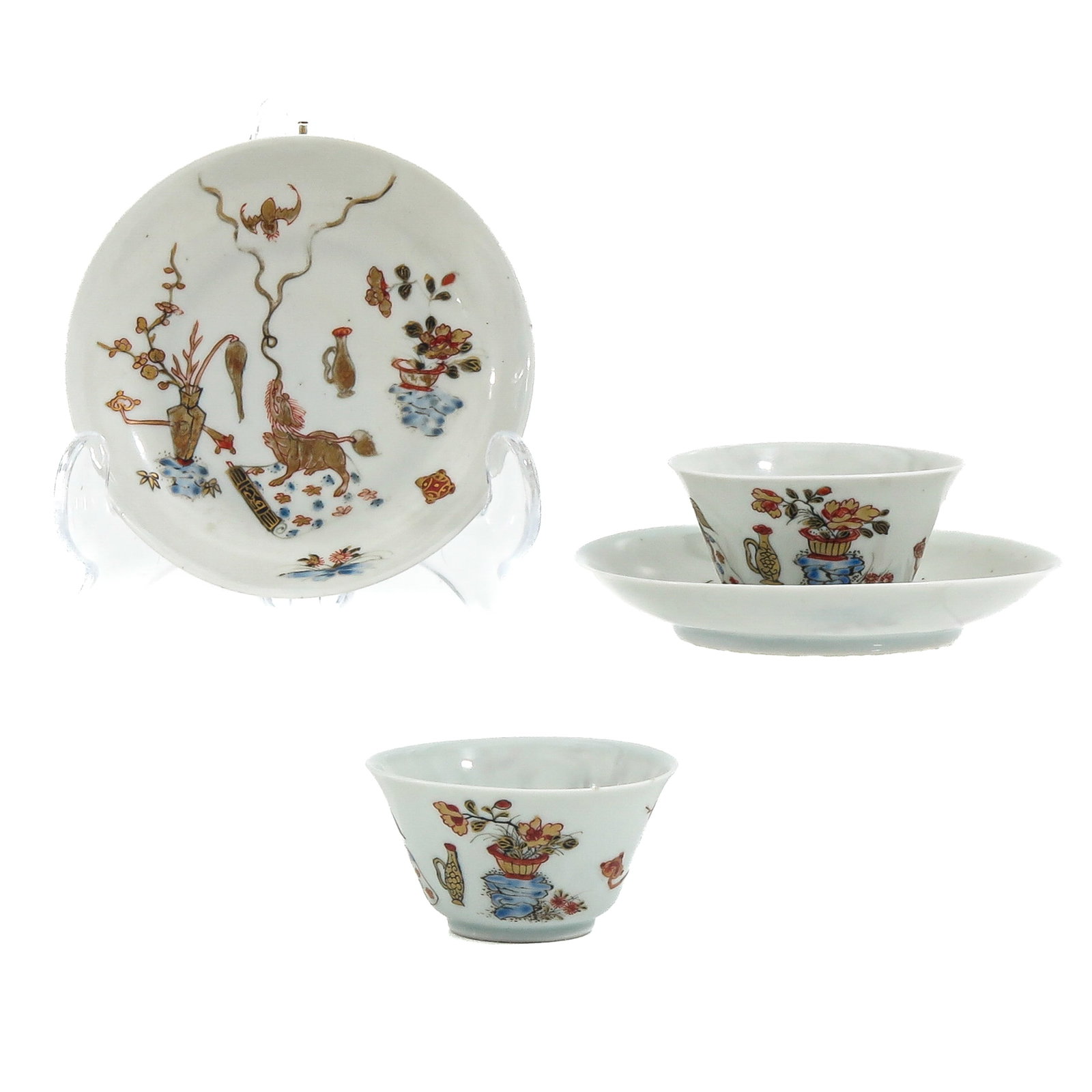 A Pair of Cups and Saucers: Polychrome decoration of flowers in vases and a landscape with figures and animals, Yongzheng period, saucers are 10 cm in diameter, chip and hairline.