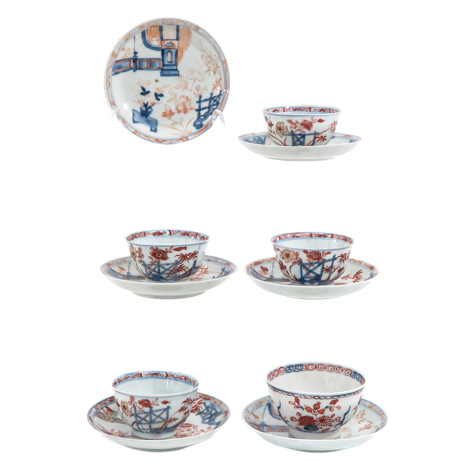 A Group of Cups and Saucers: Including 5 cups and 6 saucers, Imari decor with floral motifs and garden elements in underglaze blue and iron red, 18th Century, saucers are 12 cm in diameter, chip and hairline.