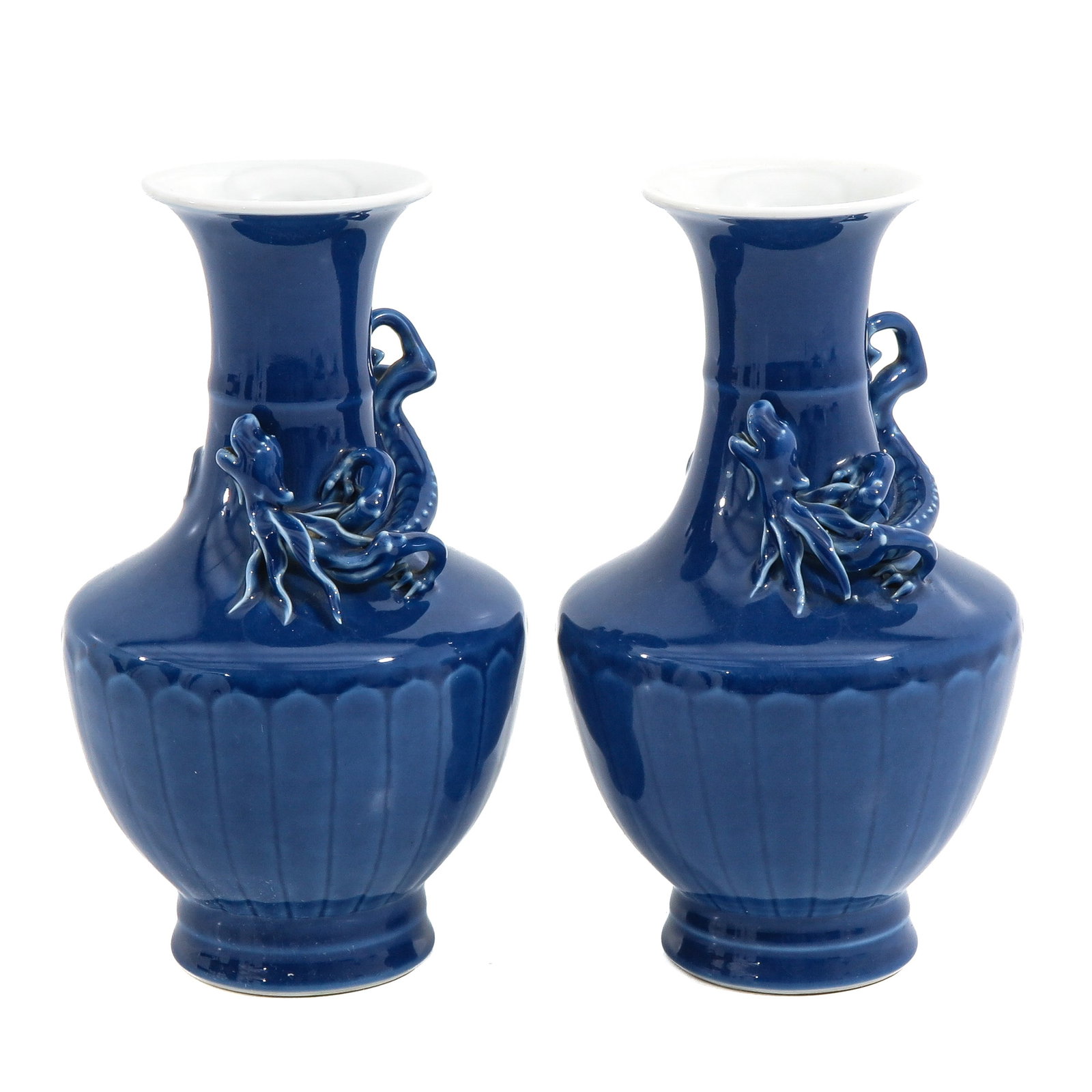 A Pair of Monochrome Blue Glaze Vases: Baluster form, decorated with applied high-relief dragons around the shoulder, Republic Period, 22 cm tall, hairline.