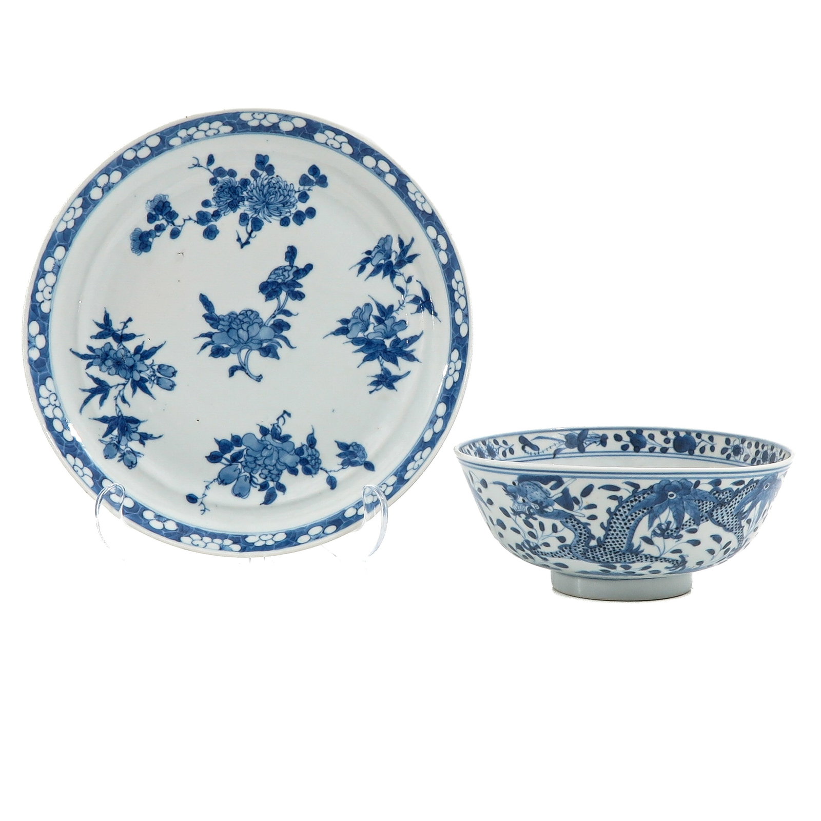 A Blue and White Plate and Bowl: Plate with floral sprays, bowl decorated with dragons and scrolling flowers with Kangxi mark, plate is 24 cm in diameter.