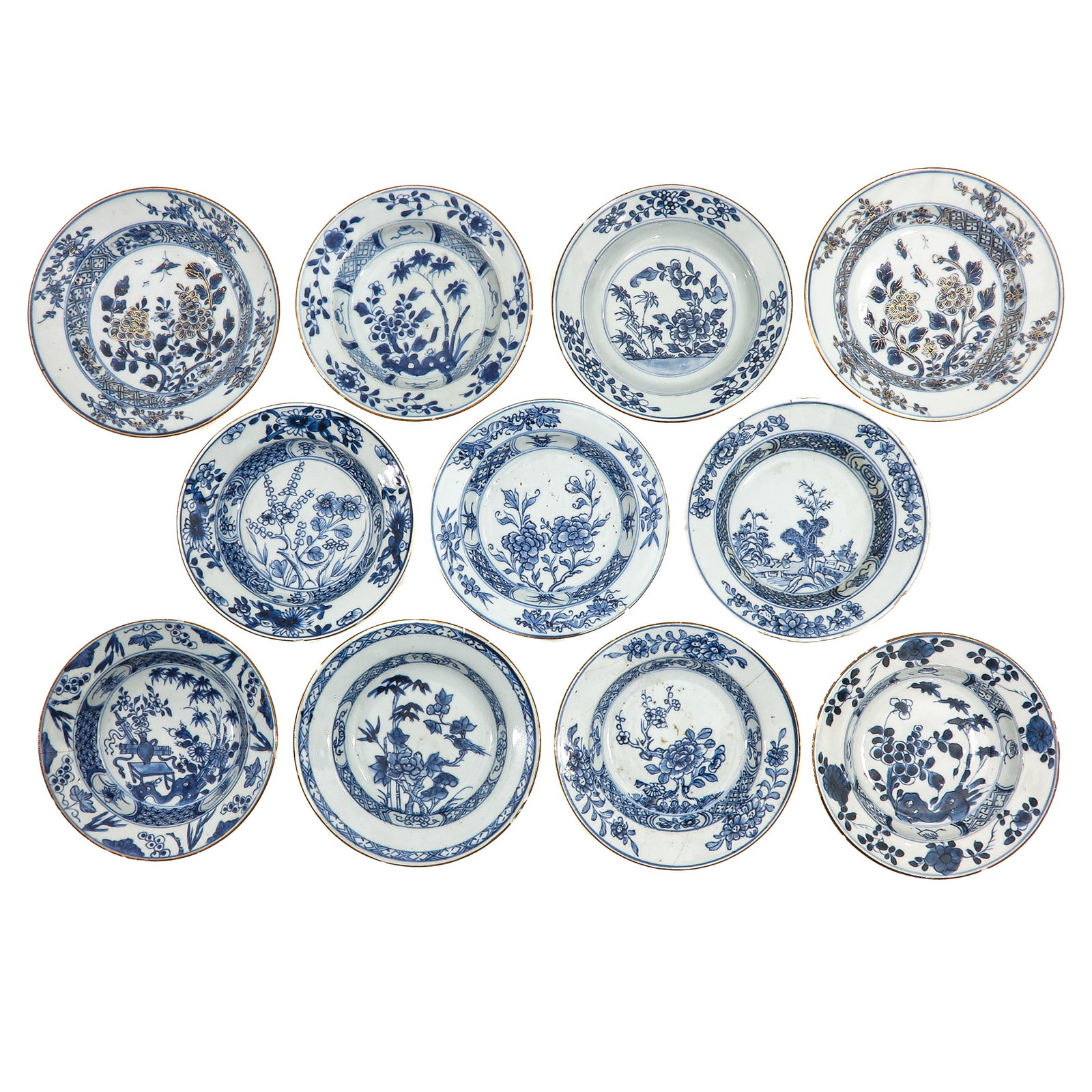 A Group of Blue and White Saucers: Decorated with floral, bird and garden landscape scenes, including 18th Century, largest saucers are 18 cm in diameter, in diverse conditions.