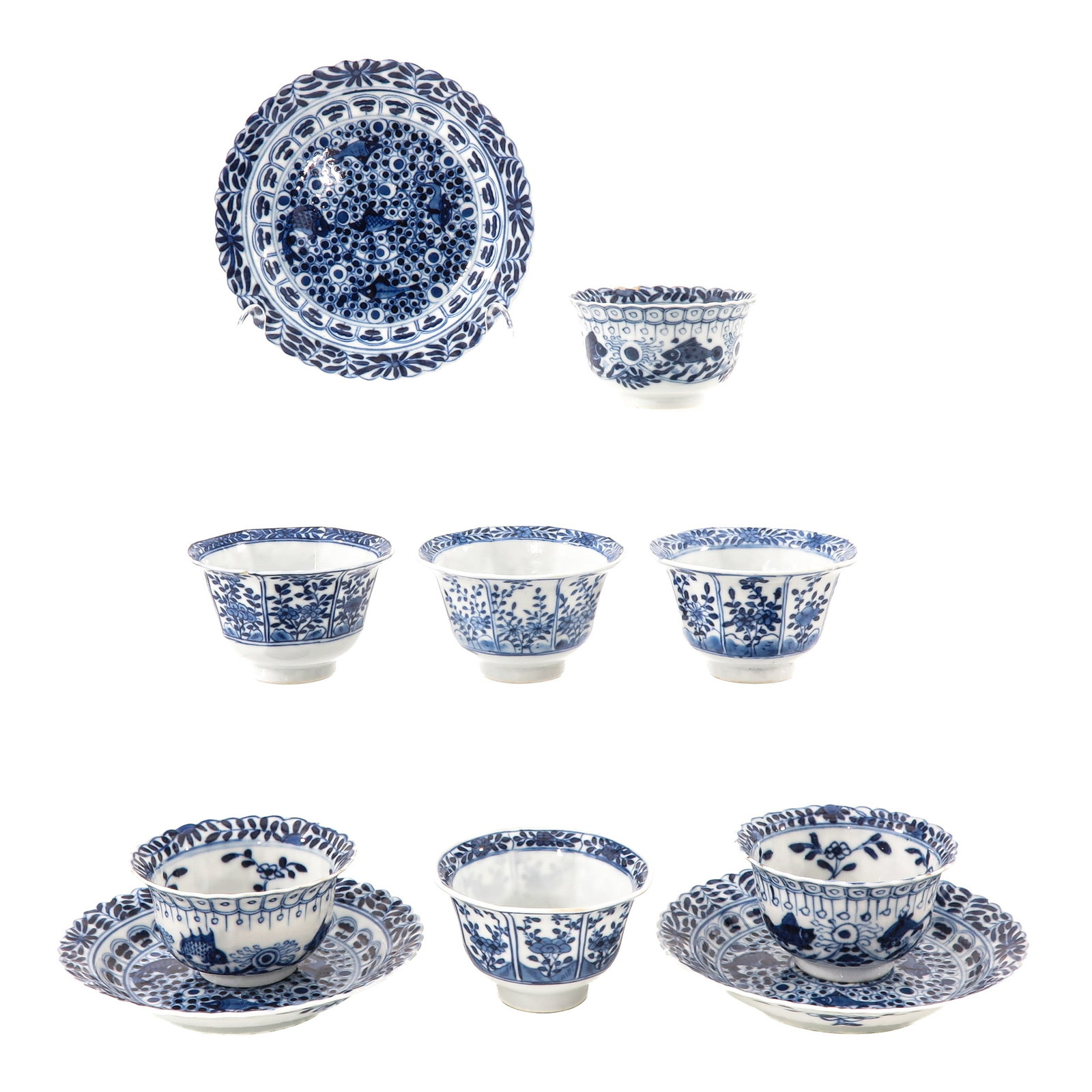 A Group of Cups and Saucers: Blue and white decor of crabs, fish and florals, including 18th Century, largest saucers are 14 cm in diameter, chip and hairline.
