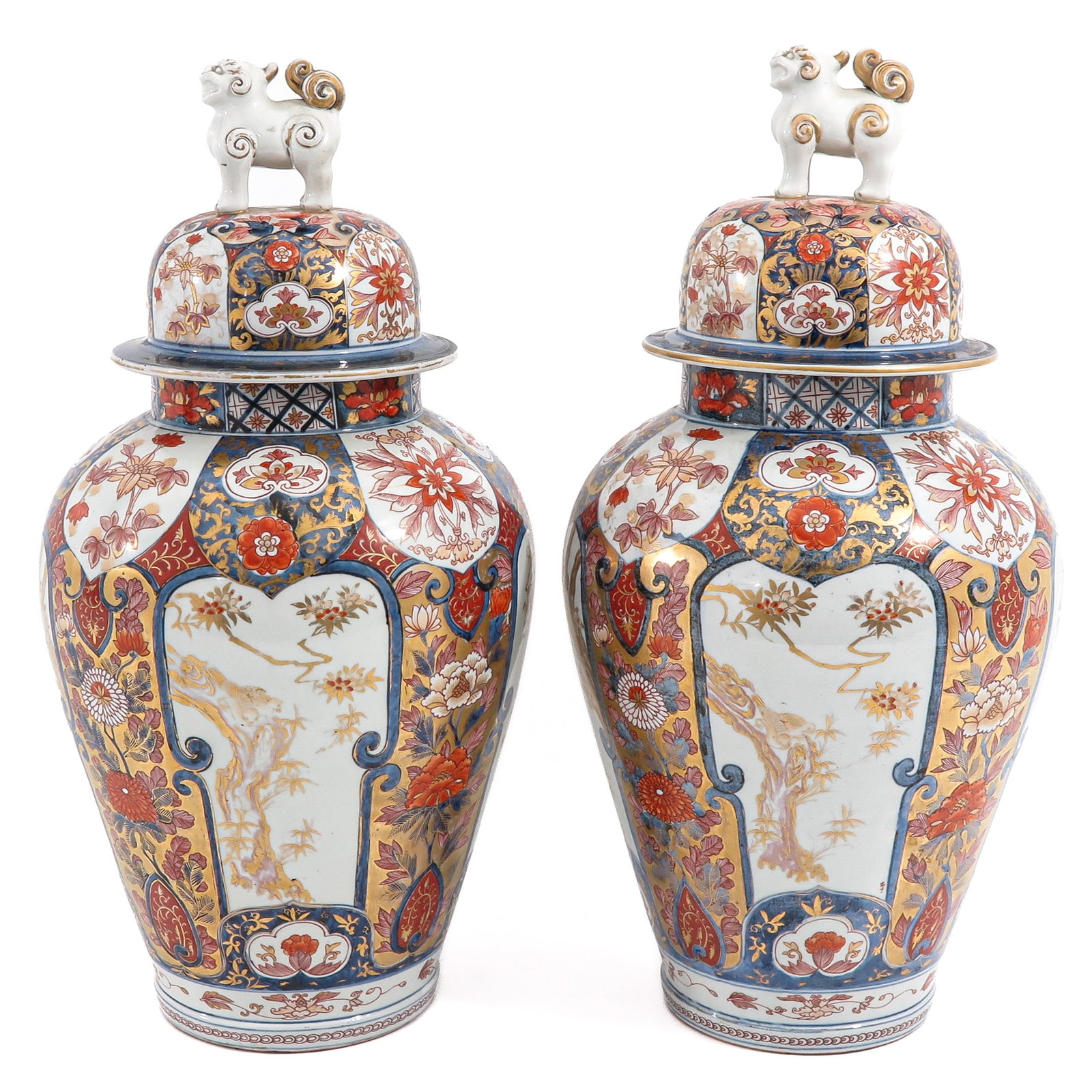 A Large Pair of Arita Jars with Covers: Floral decor in iron red, blue and gilt enamels, temple lions on covers, circa 1700, 62 cm tall.
