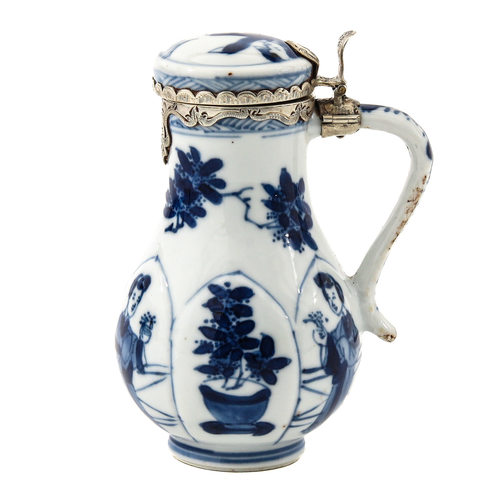 A Small Pitcher with Silver Mountings: Decorated with scenes of flowers and Chinese ladies, with silver mountings, Kangxi Period, 10 cm tall, small chip on rim, hairline.