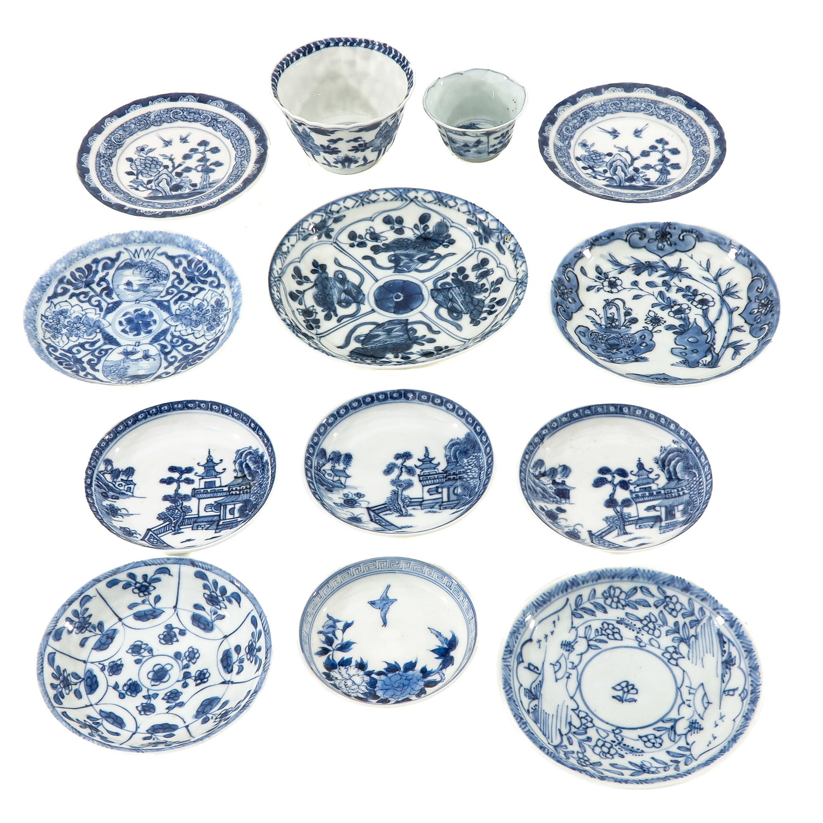 A Group of Blue and White Saucers: In various decors including landscapes and floral and bird motifs, including 18th Century, largest saucer is 13 cm in diameter, chip and hairline.