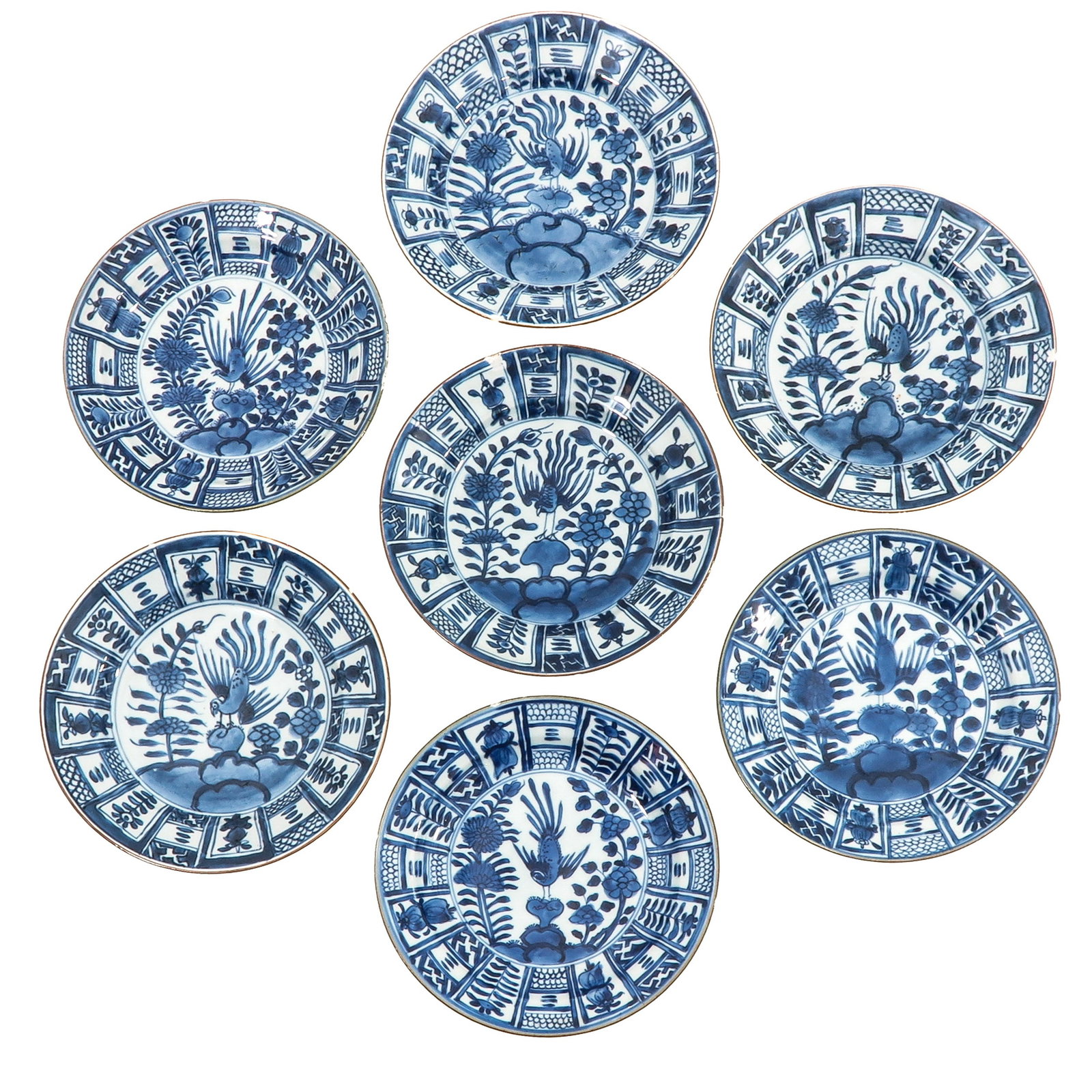 A Collection of 7 Blue and White Plates: In a variety of decors, including decor of phoenix and floral motifs, 18th Century, 22 cm in diameter, in diverse conditions.