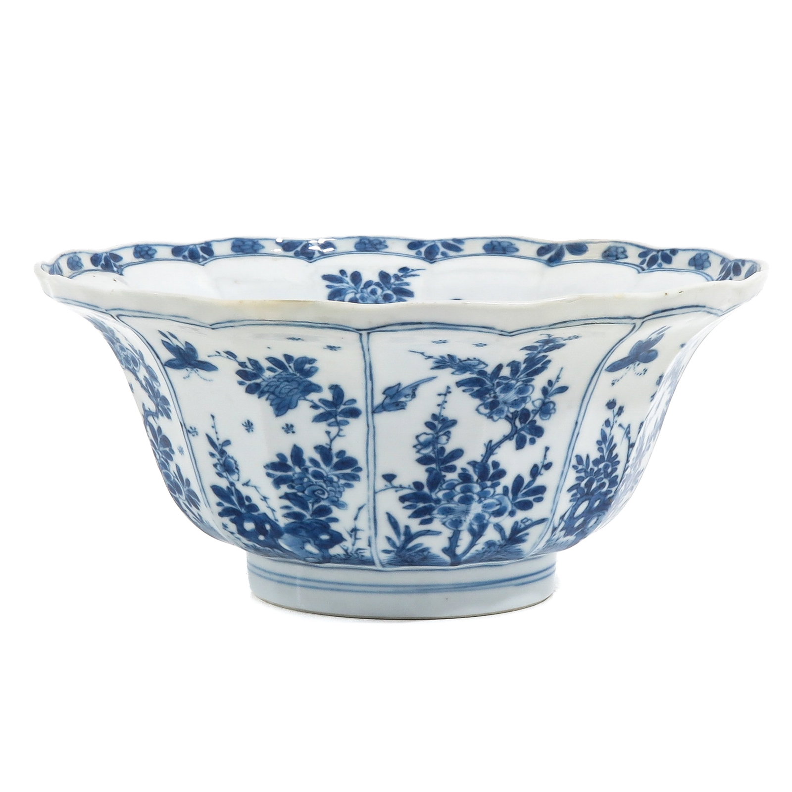 A Blue and White Bowl: Decorated with floral panels and insects, with lobed rim, Kangxi Period, 21. cm, restored.
