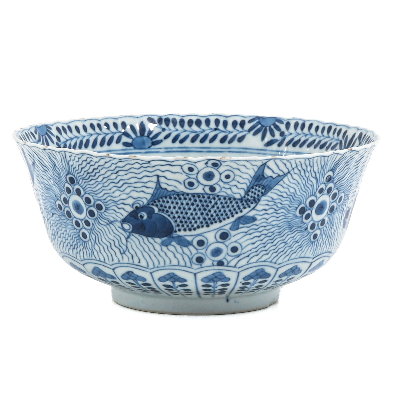 A Blue and White Bowl: Decorated with fish among wave patterns and roundels, the rim with stylized floral border, Kangxi Mark, 18th / 19th Century, 20 cm in diameter, fritting.