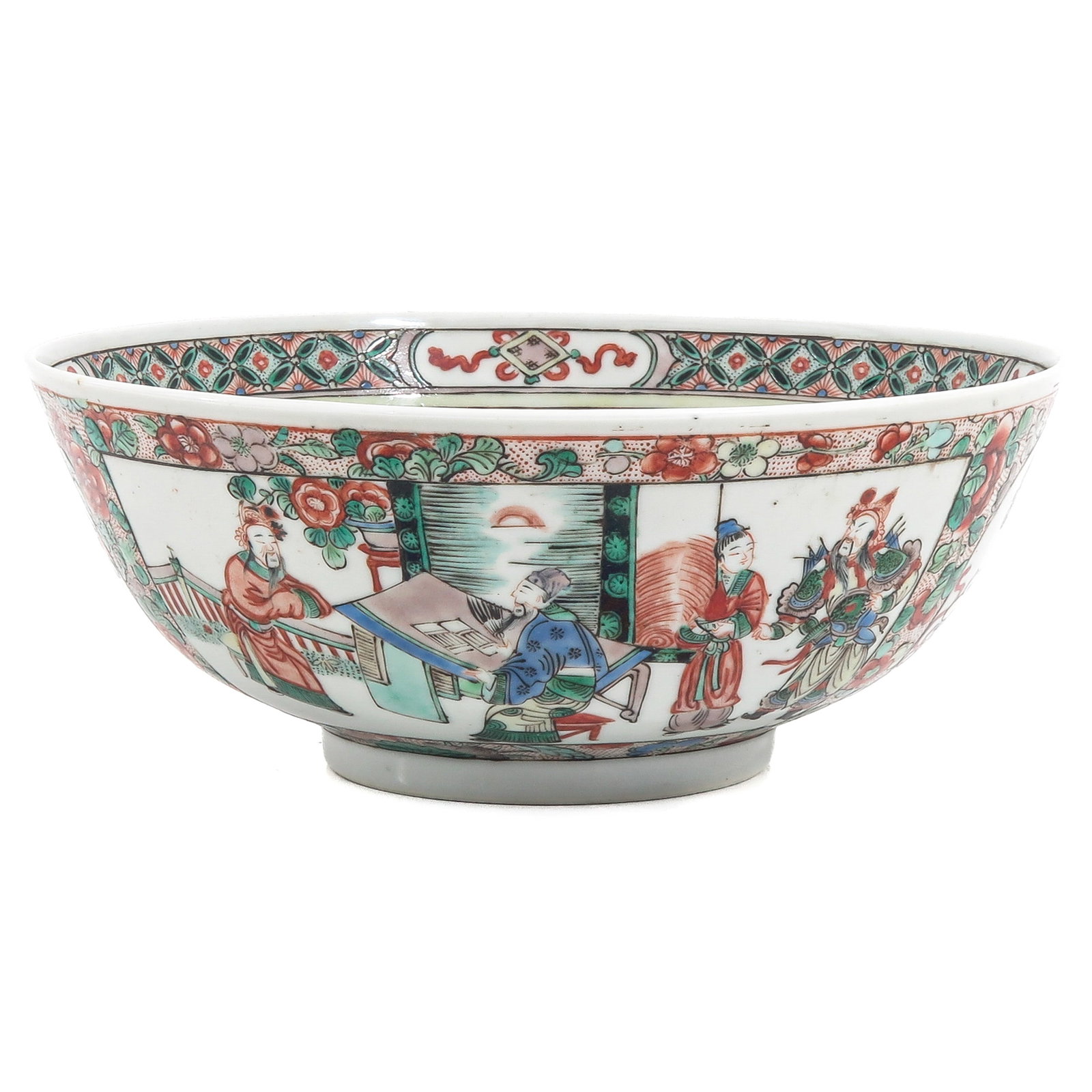 A Famille Verte Bowl: Decorated with a continuous scene of figures in an interior and garden setting, 18th / 19th century, 23 cm in diameter.