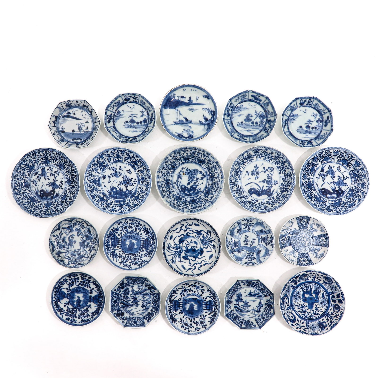A Large Collection of Saucers: Decorated in blue and white motifs of flowers, landscapes and and figural scenes, including 18th Century, largest saucer is 14 cm in diameter, in diverse conditions.