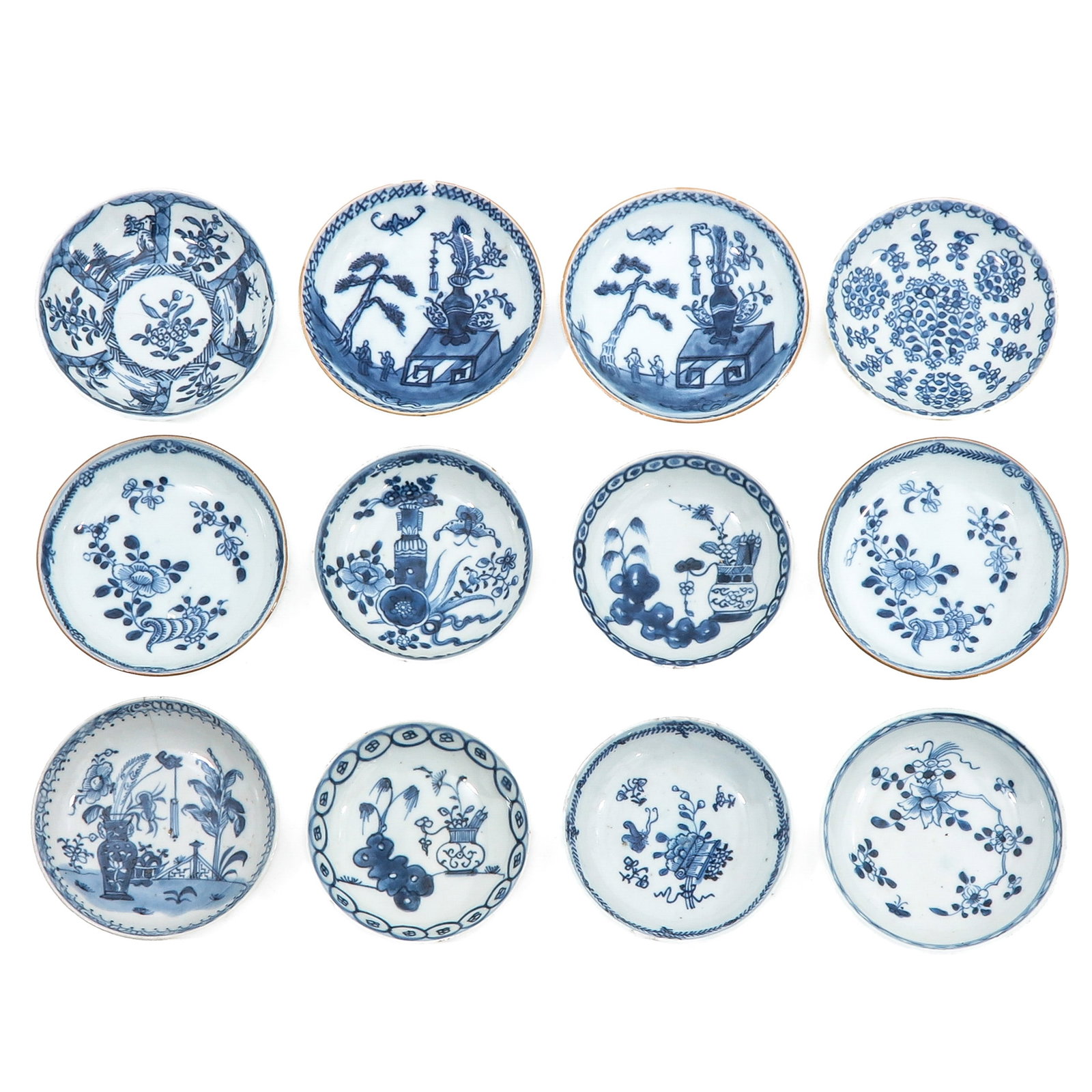 A Group of Blue and White Saucers: In a variet of motifs such as scholar’s objects and landscapes, including 18th Century, saucers are 12 cm in diameter, chip and hairline.