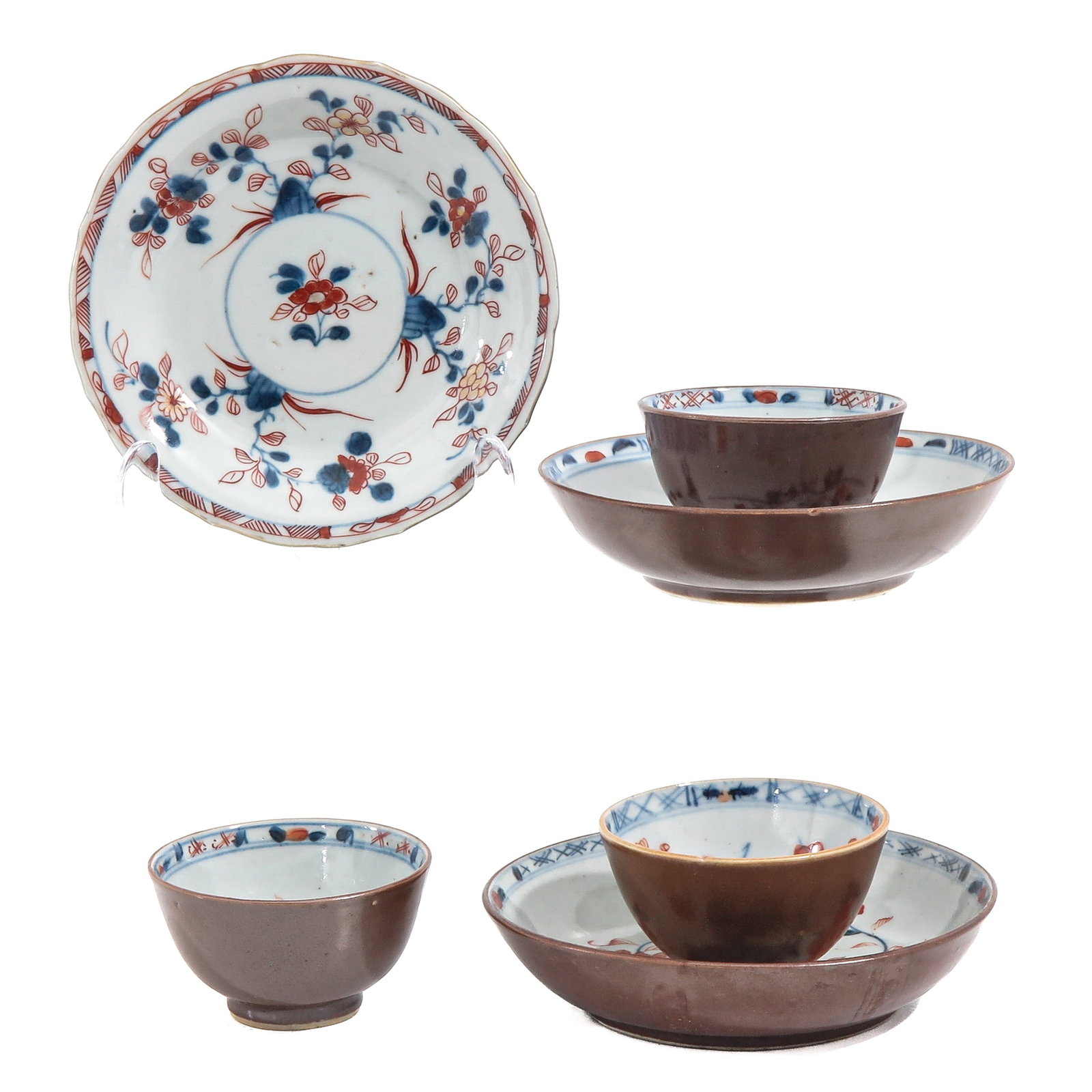 A Set of Batavianware Cups and Saucers: Including 3 cups and saucers, decorated in underglaze blue and iron red with floral motifs, 18th Century, saucers are 14 cm in diameter, chip and hairine.