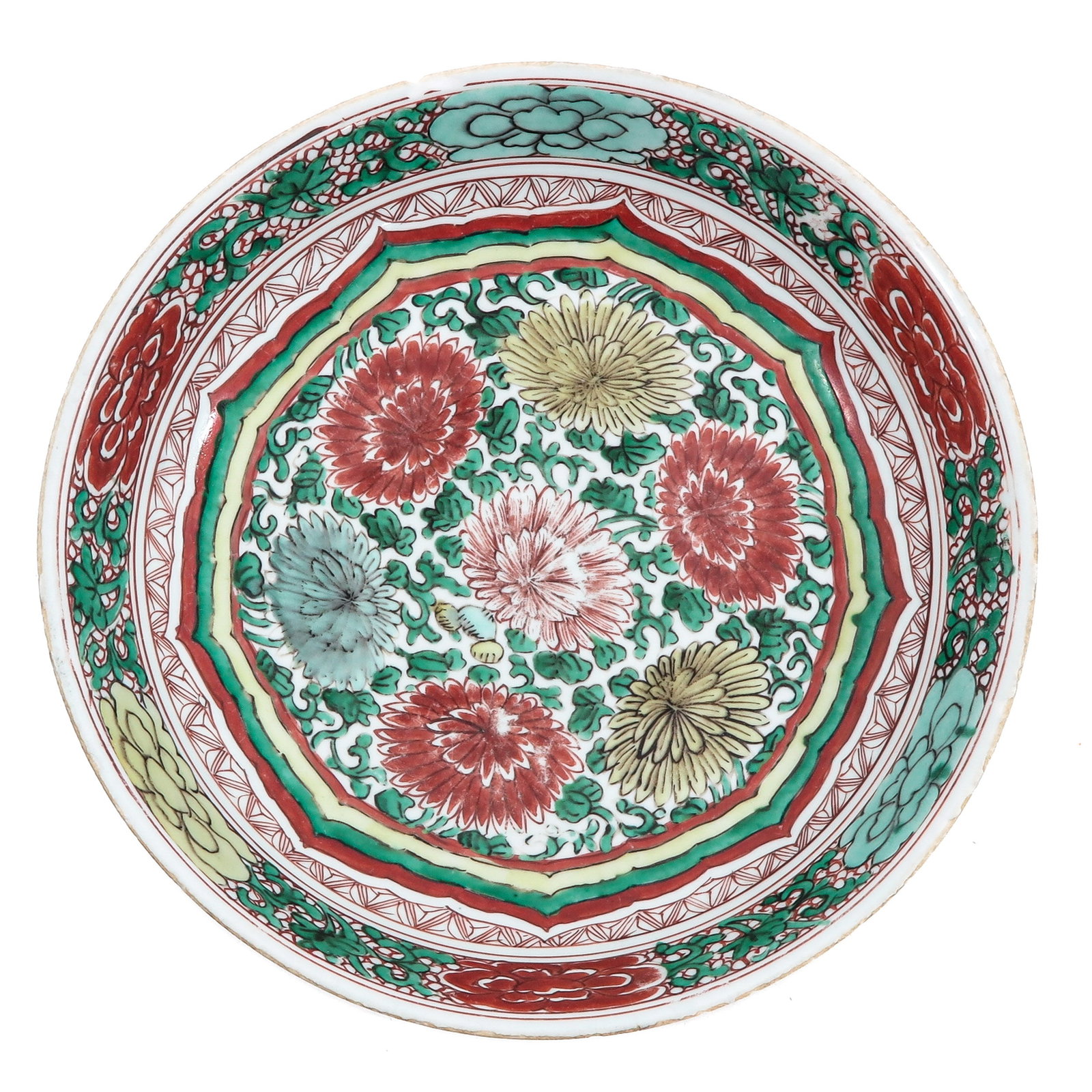 A Famille Verte Charger: Centrally decorated with chrysanthemums and floral scrolls within a geometric and floral borders, 28 cm in diameter, chip and hairline.