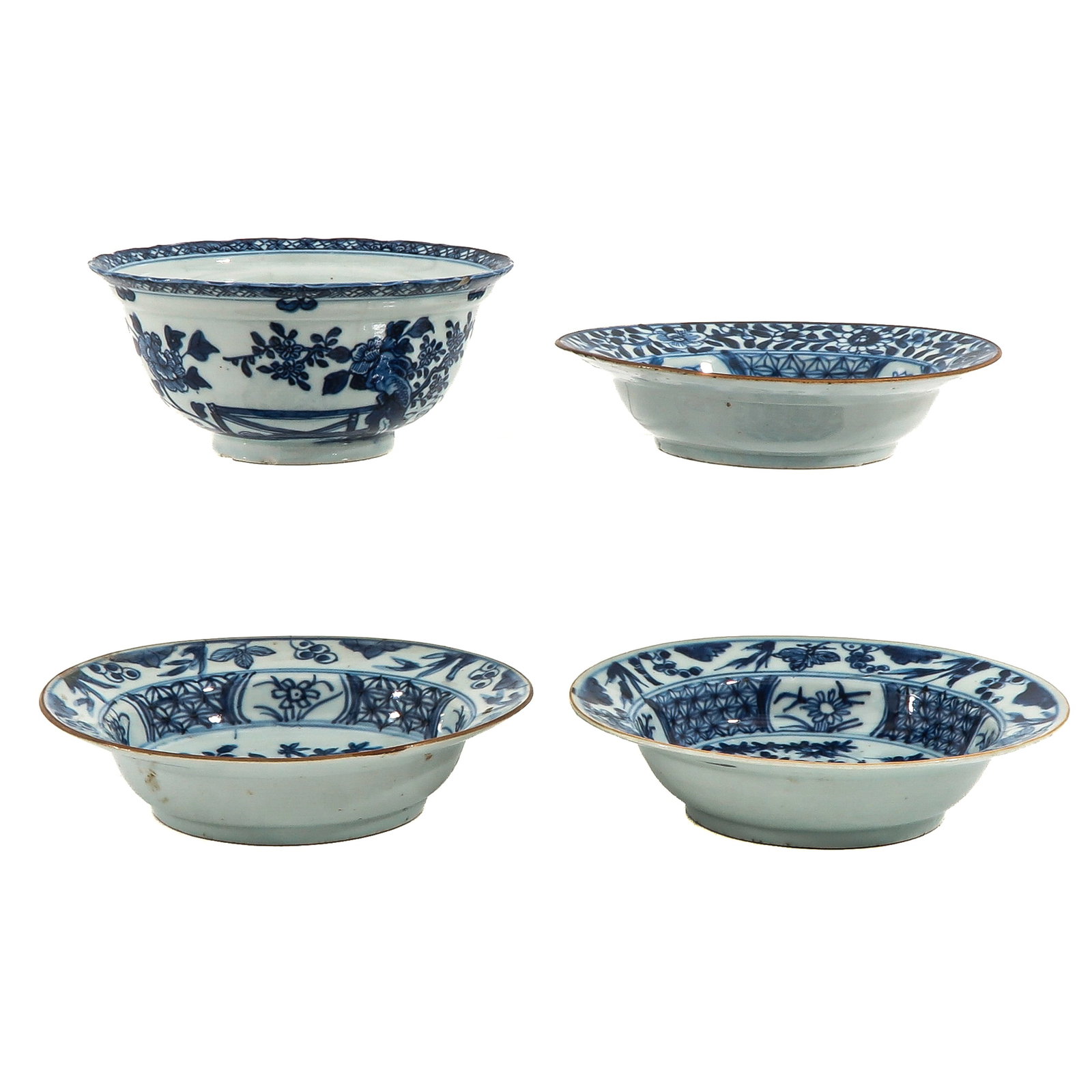 A Group of Blue and White Porcelain: Including 4 bowls decorated with floral motifs and stylized borders in underglaze blue, including 18th Century, largest bowl is 16 cm in diameter, chip and hairline.