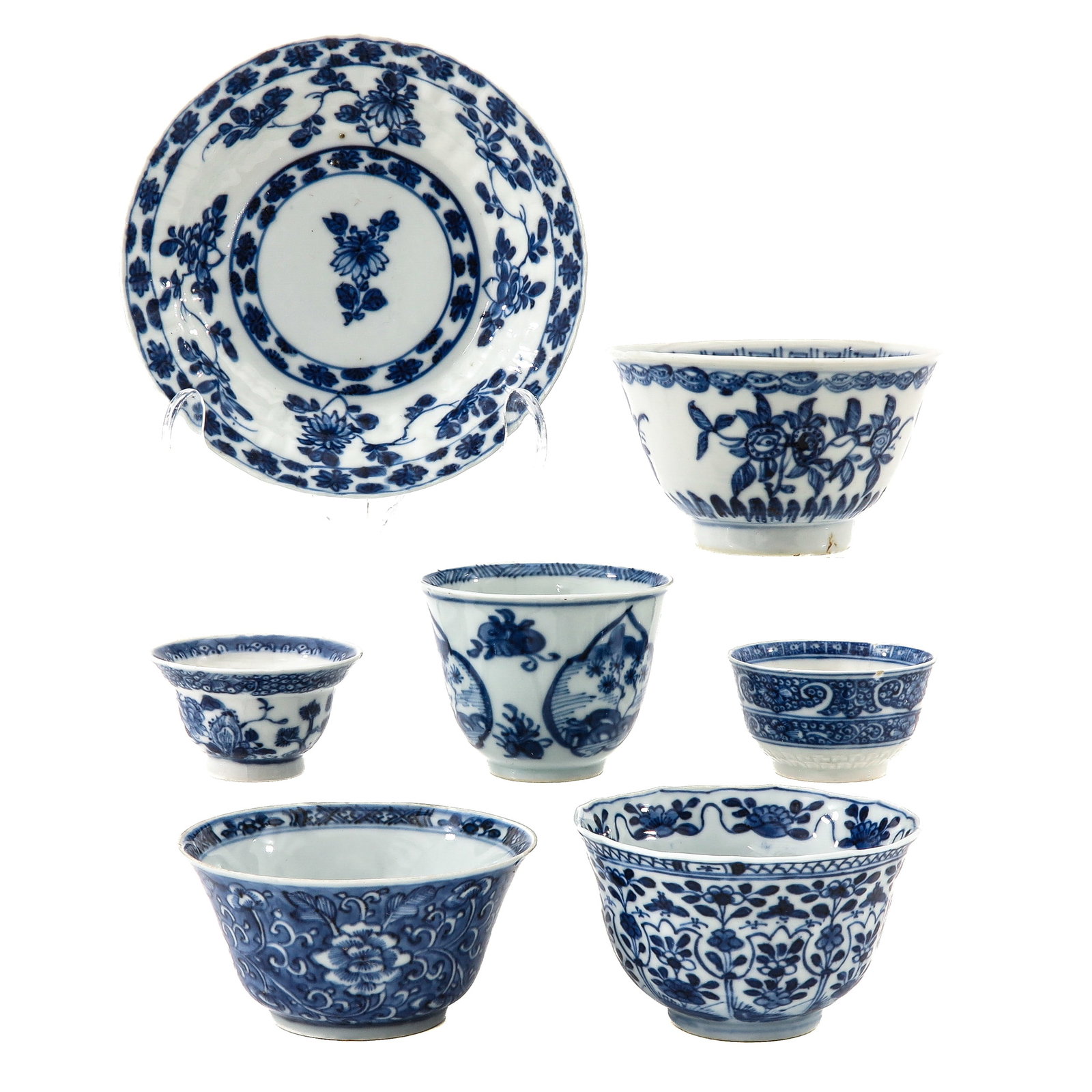 A Group of Blue and White Cups and a Saucer: Decorated with floral and scrolling motifs, including 18th Century, saucer is 13 cm in diameter, chip and hairline.