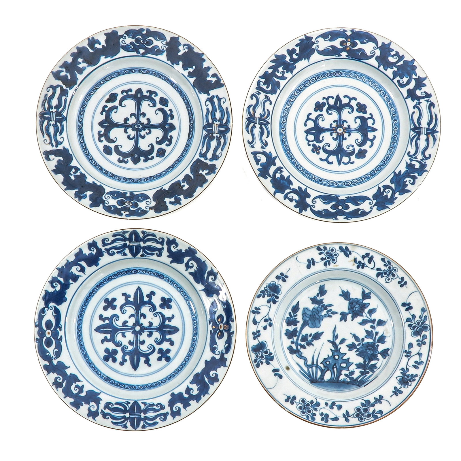 A Group of 4 Blue and White Plates: Decorated with floral and garden motifs, 18th Century, 23 cm in diameter, chip and hairline.