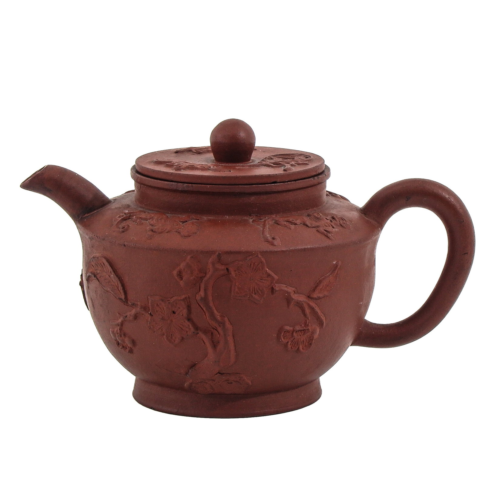 A Yixing Teapot: Relief floral decor, 9 cm tall.