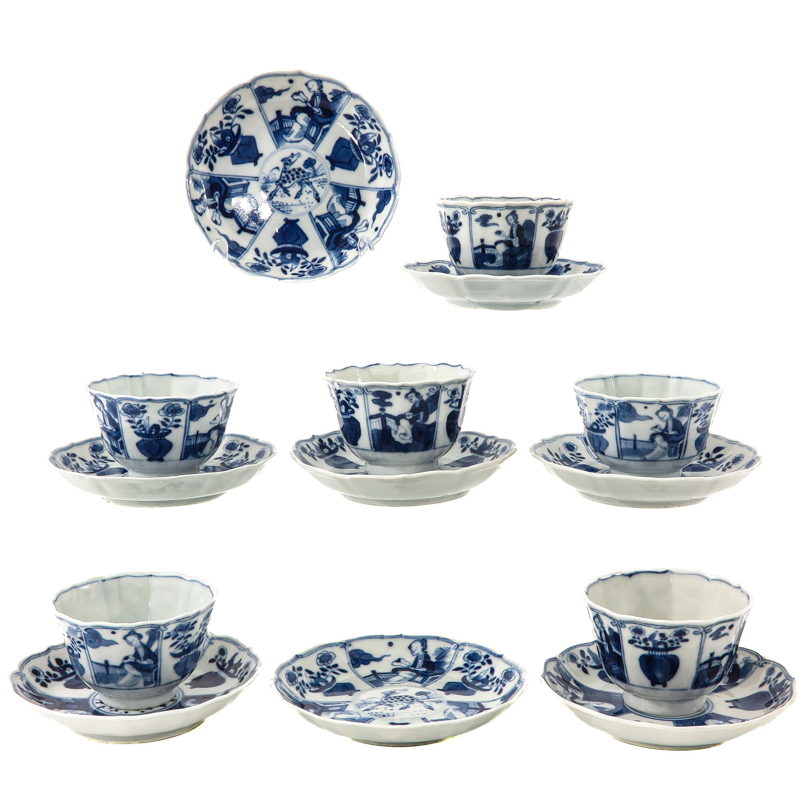 A Group of Blue and White Cups and Saucers: Decorated with garden scenes with figures and flowering vases, 18th Century, saucers are 13 cm in diameter, chip and hairline.
