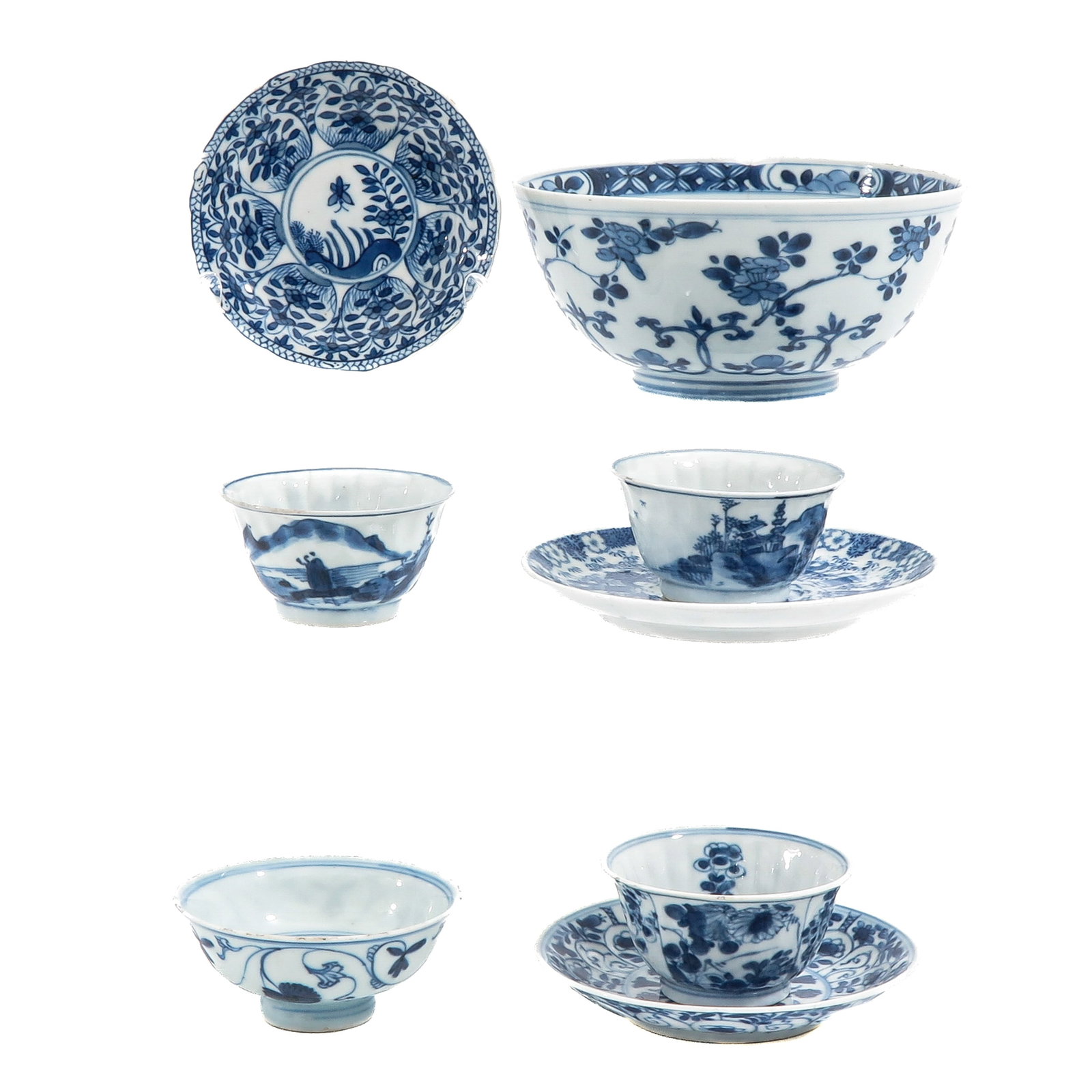 A Group of Blue and White Porcelain: Including a small bowl, cups and saucers and a stemmed tea cup, in a variety of floral motifs, landscapes and panel designs, 18th Century, vowl is 15 cm in diameter, chip and hairline.