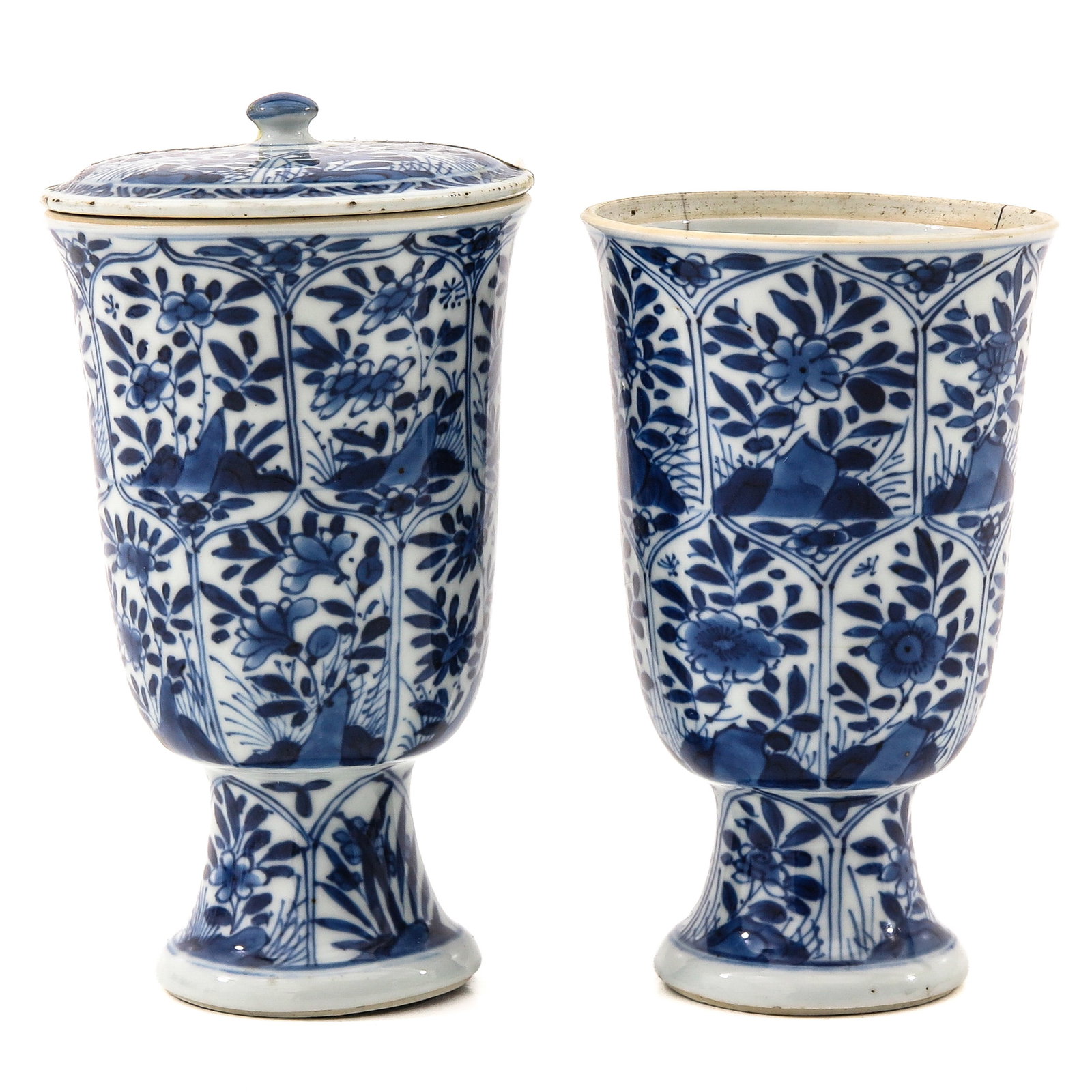 A Pair of Blue and White Vases with Cover: Decorated with panels of flowers, 18th Century, 15 cm tall, in diverse conditions, one cover missing.