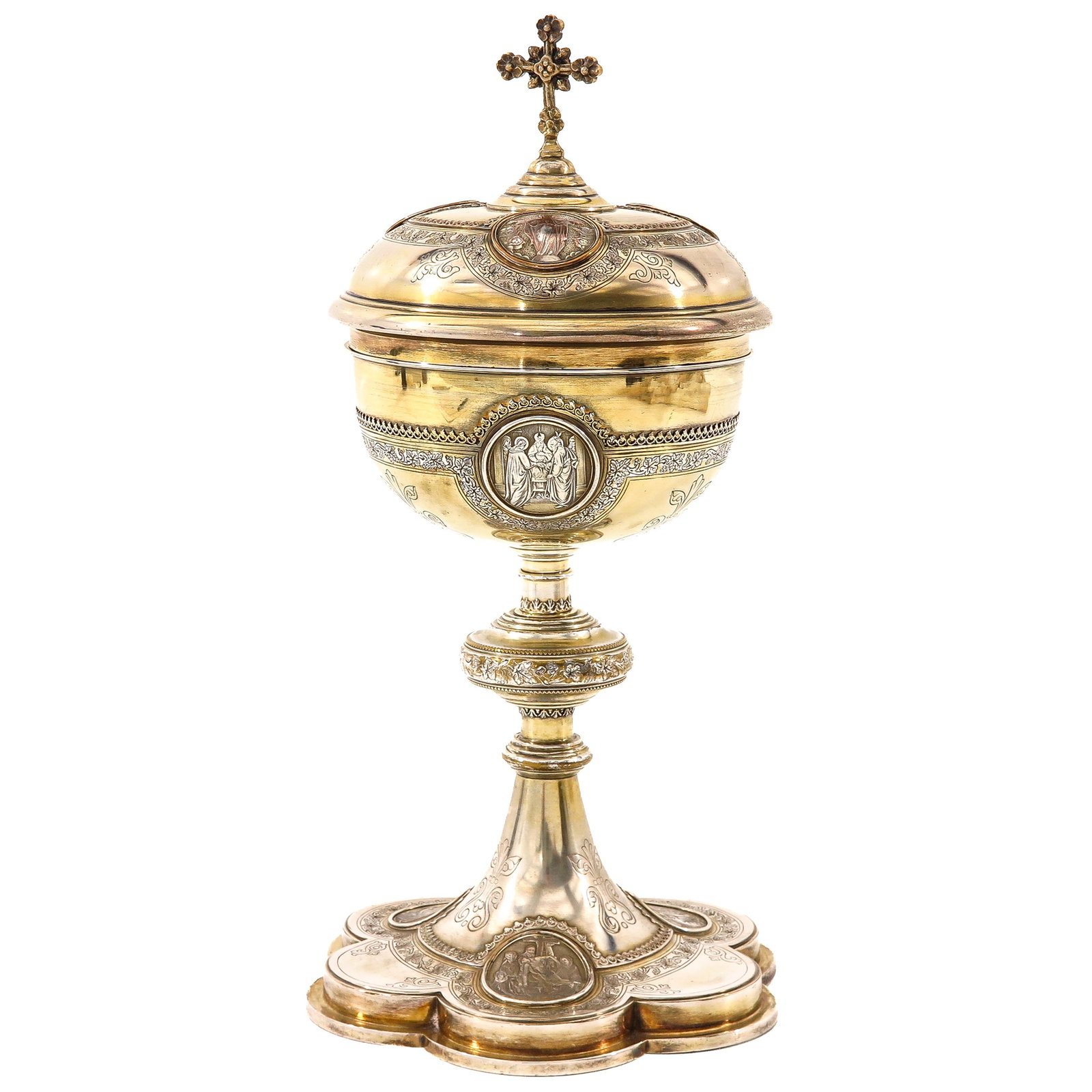 A Solid Silver Ciborium: 19th century, solid silver with remnants of gilding, richly decorated with detailed appliqués depicting biblical scenes, height 32 cm.
