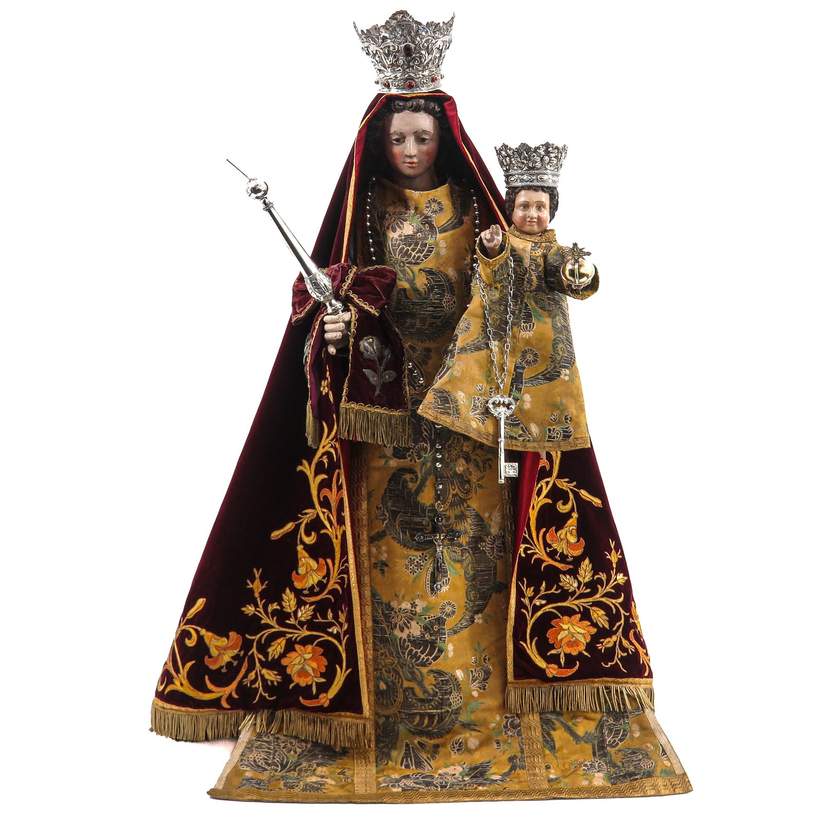 A Very Rare Madonna: 18th century, very finely dressed in rich velvet with exceptionally fine gold thread embroidery, with silver crowns, rosary, scepters and heavenly key, including 17th/18th century, height 113 cm.