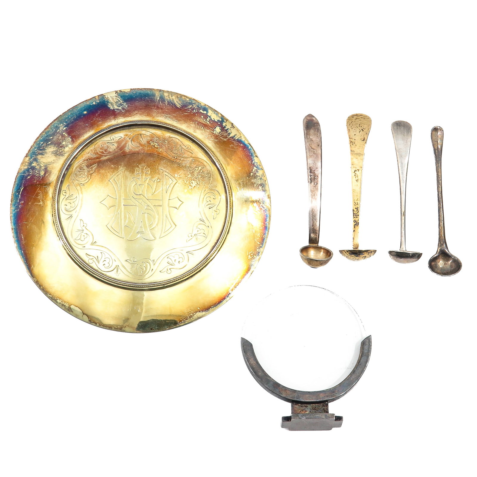A Collection of Religious Items: consisting of a gilded silver paten engraved with IHS monogram, together with four small spoons and a luna holder