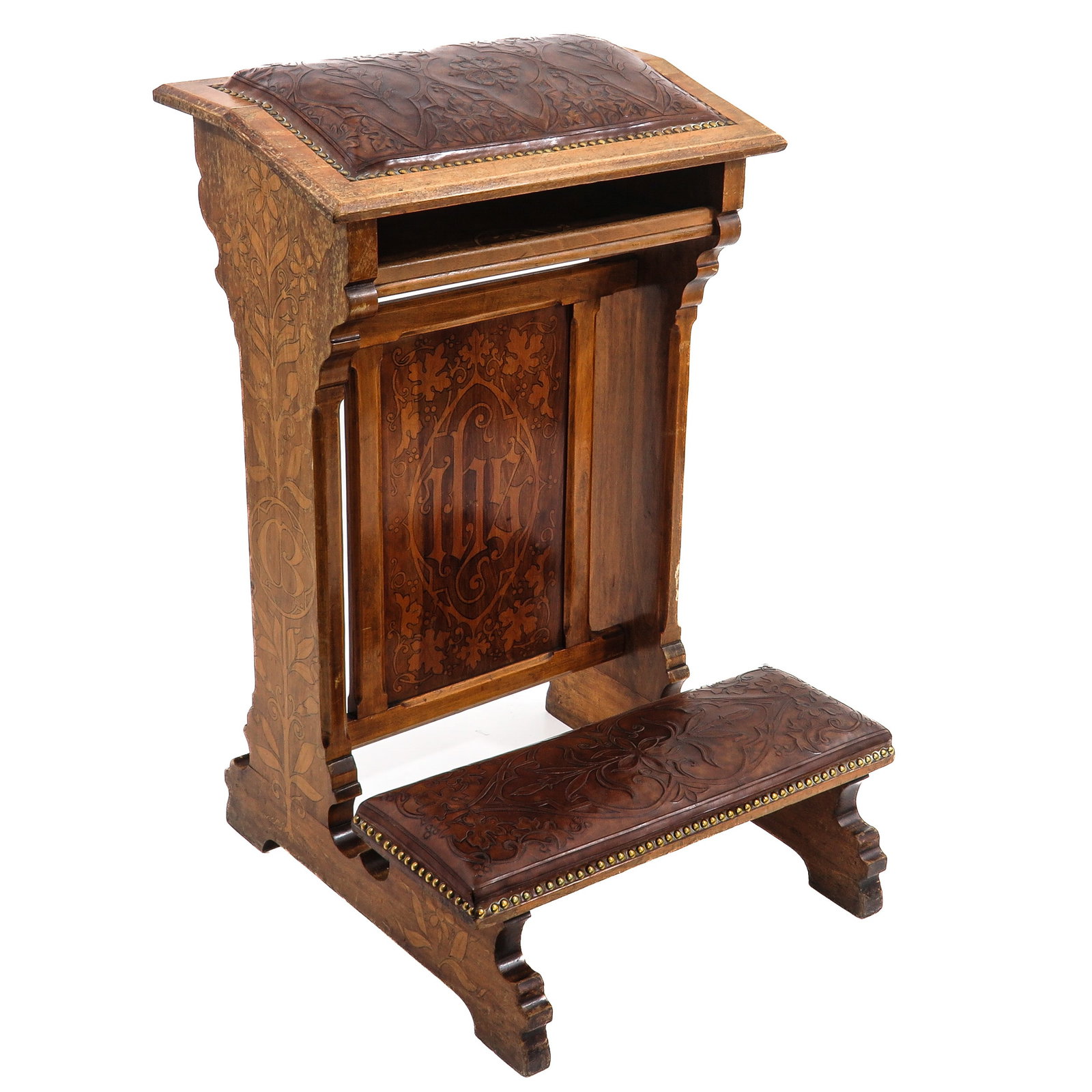A Fine Prie-dieu with Embossed Leather: of wood with very fine marquetry work, the front panel inlaid with the IHS monogram, the kneeling bench and lectern covered with finely stamped leather, ca. 1880 - 1900, height 87 cm.