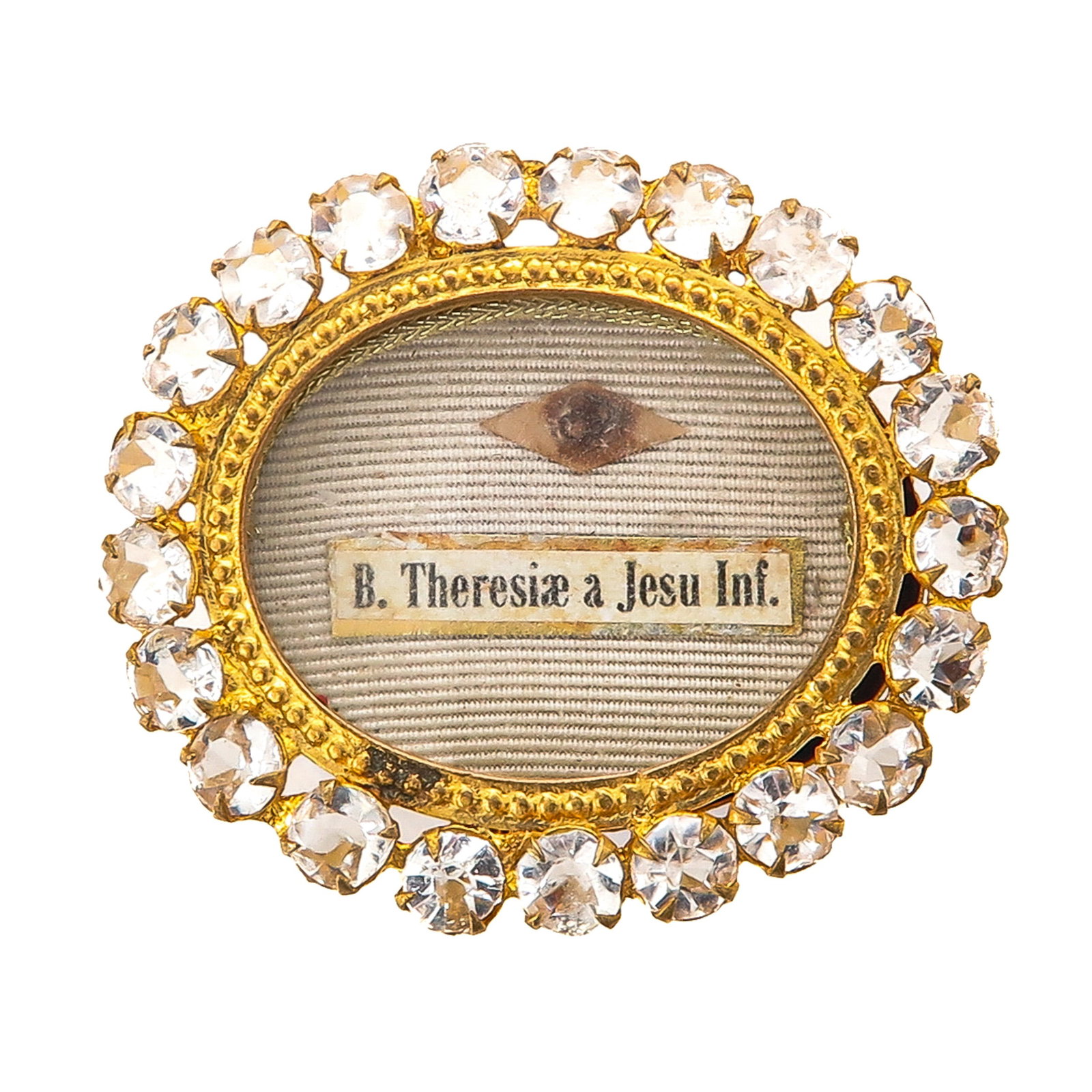 Sealed reliquary: set with small stones, containing a relic of Saint Theresa of the Child Jesus (Carmelite nun, patroness of missions, among others), 5 x 4 cm., you are buying the display case, the relics are a gift