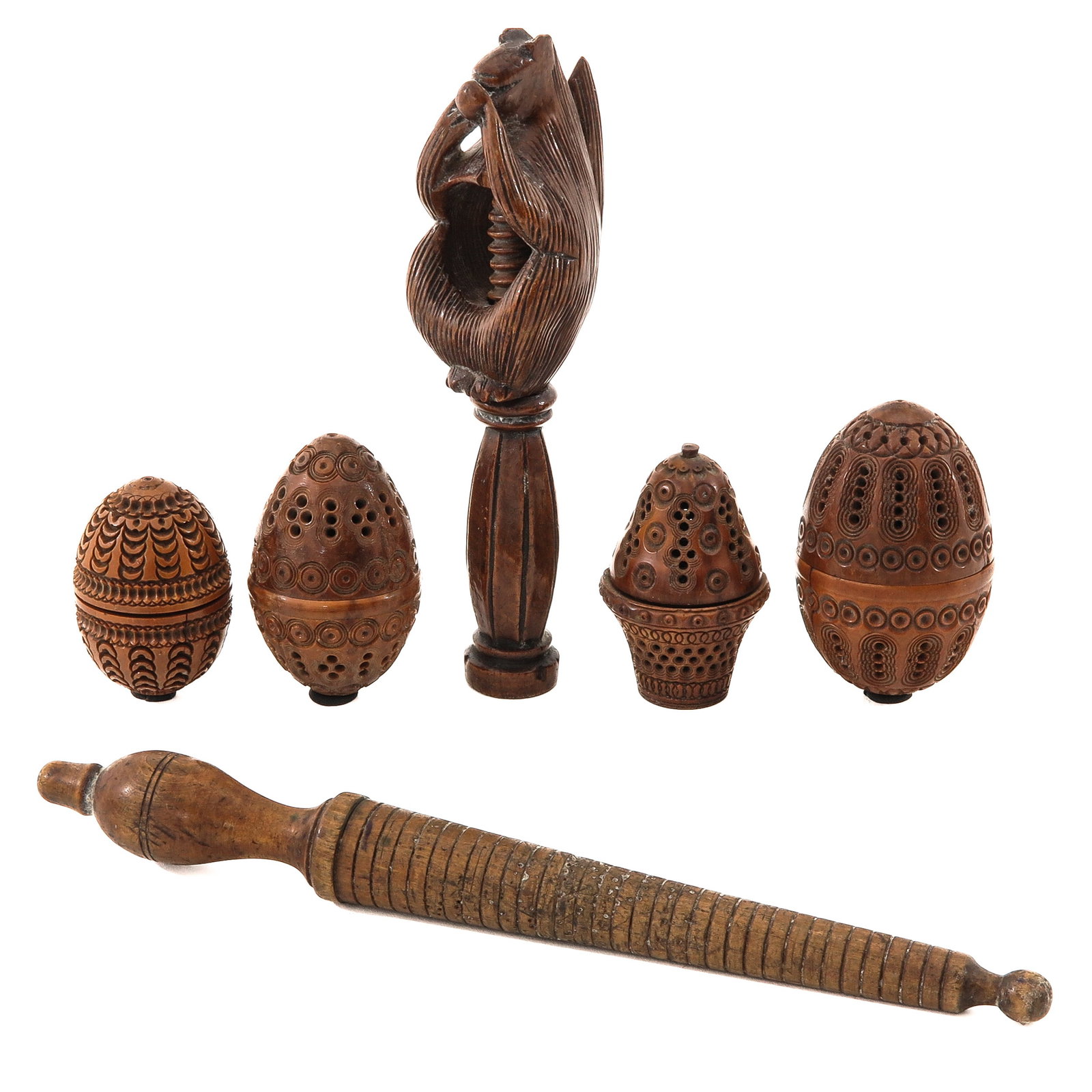 A Collection of Carved Wood Items: consisting of a collection of hand-carved objects, including coquillanut needle cases, 19th century, longest 24 cm.