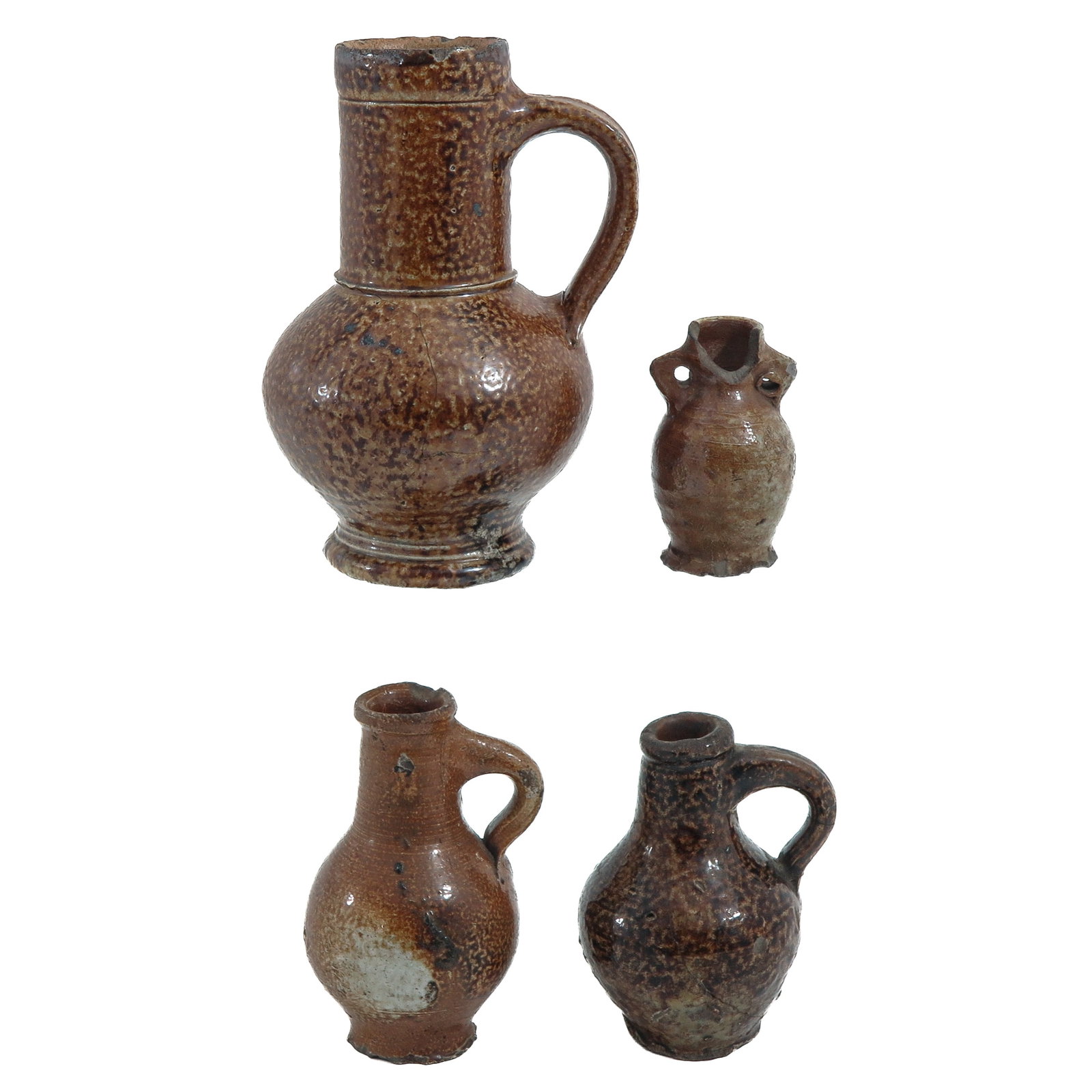A Lot of 4 Earthenware Jugs: consisting of 4 earthenware jugs, in various designs, tallest 17 cm.