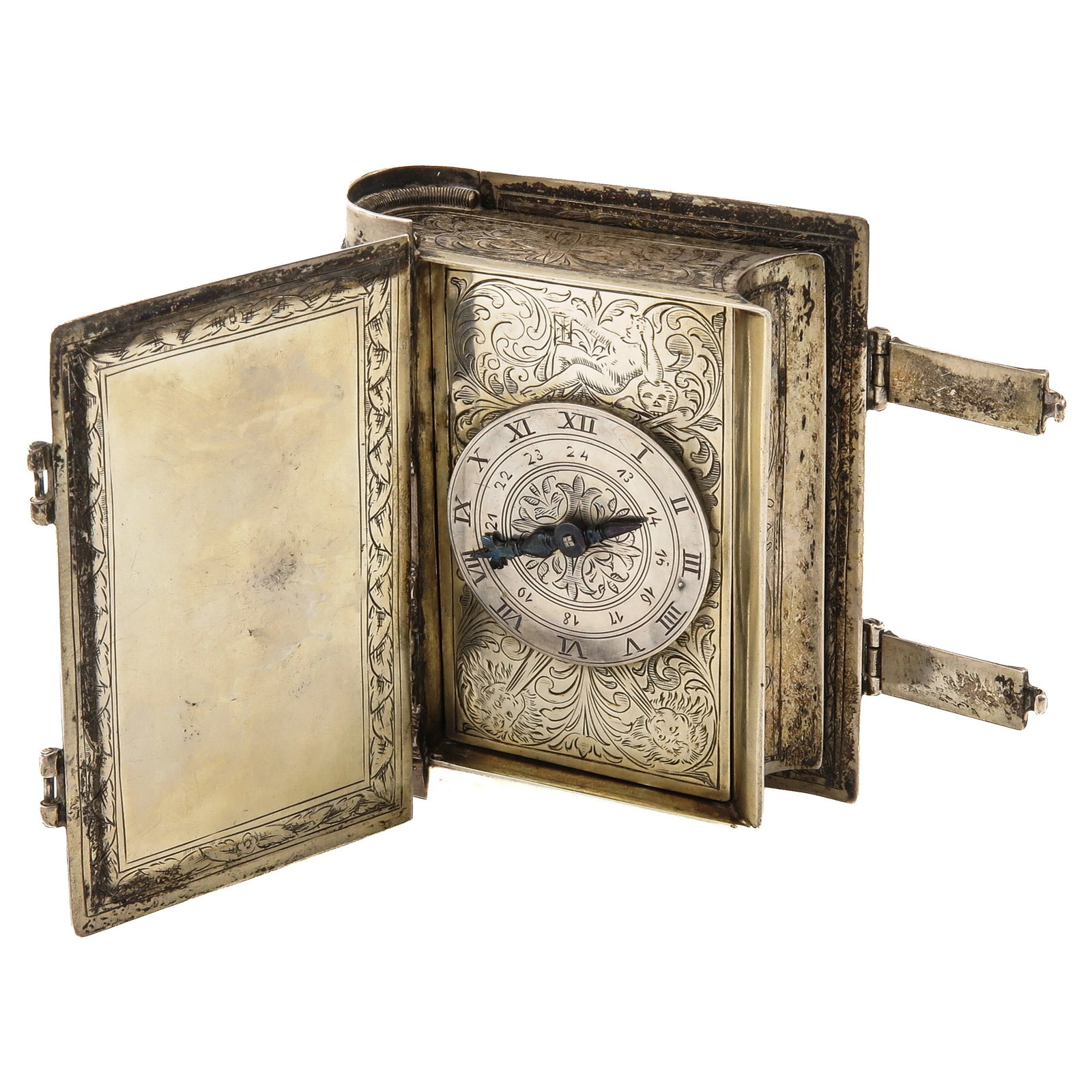 A Travel Clock: in the form of a book, silver-plated brass, finely engraved with foliage and allegorical figures, ca. 1700, 9 x 11 x 3,5 cm.