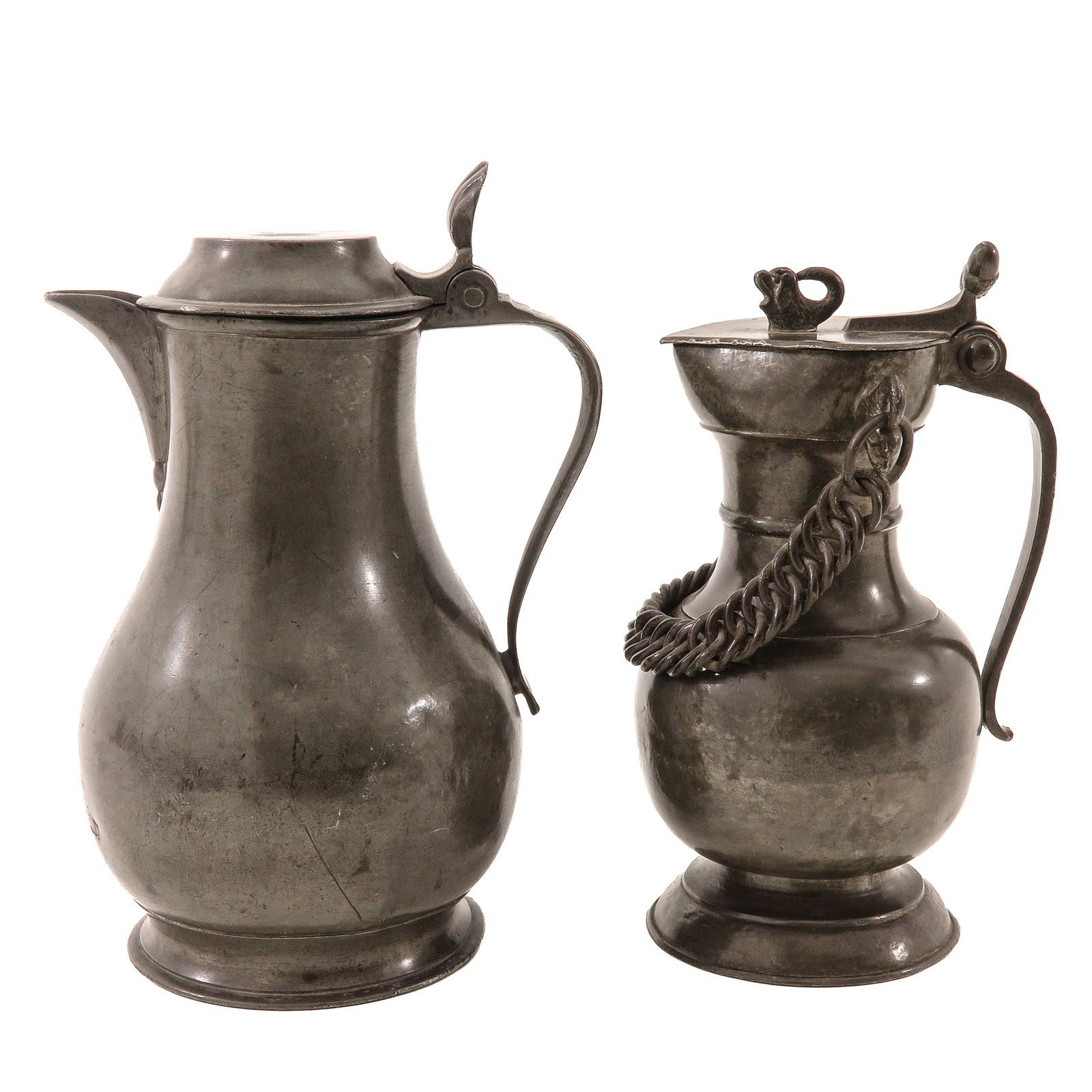 A Lot of 2 Pewter Jugs: consisting of an 18th-century Swiss pewter wine jug (Bauchkanne) with chain, height 24 cm. and a Flemish pewter jug, height 27 cm.