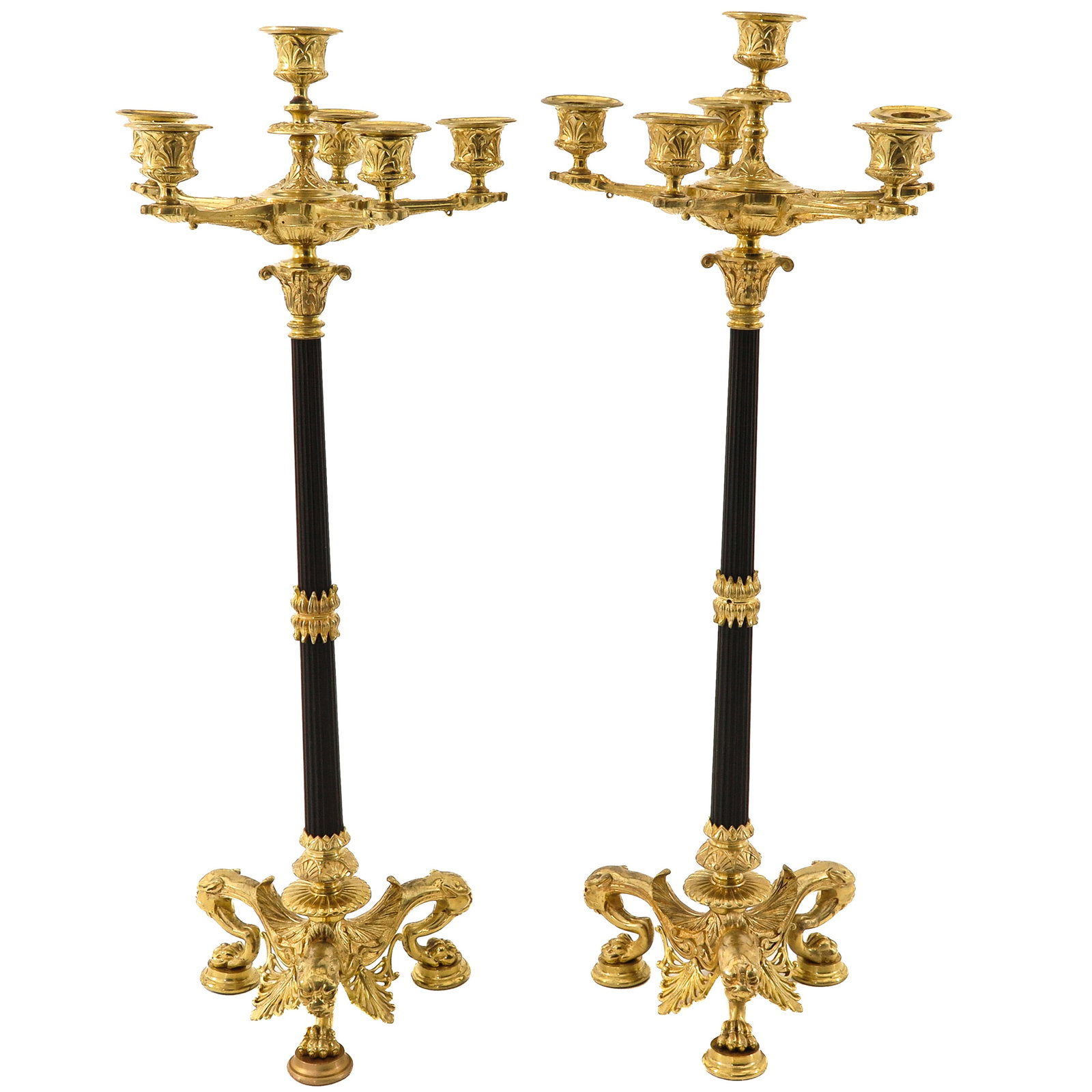 A Pair of Candelabras: candelabras, of gilt bronze and patinated metal, each with 6 light points, on base with winged griffins, height 62 cm.