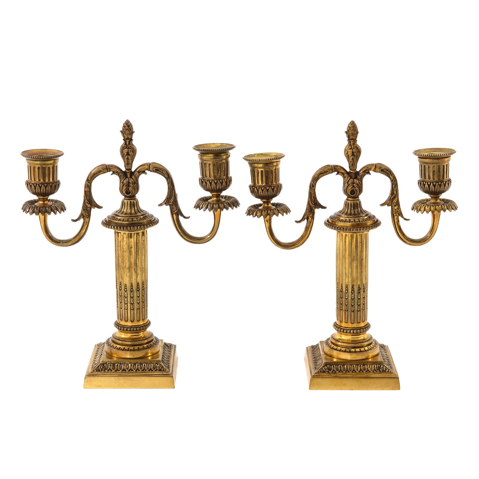 A Pair of Candlesticks: candlesticks, gilt bronze, with fluted columns on square base, signed Cailar Bayard, Christofle, height 24 cm.