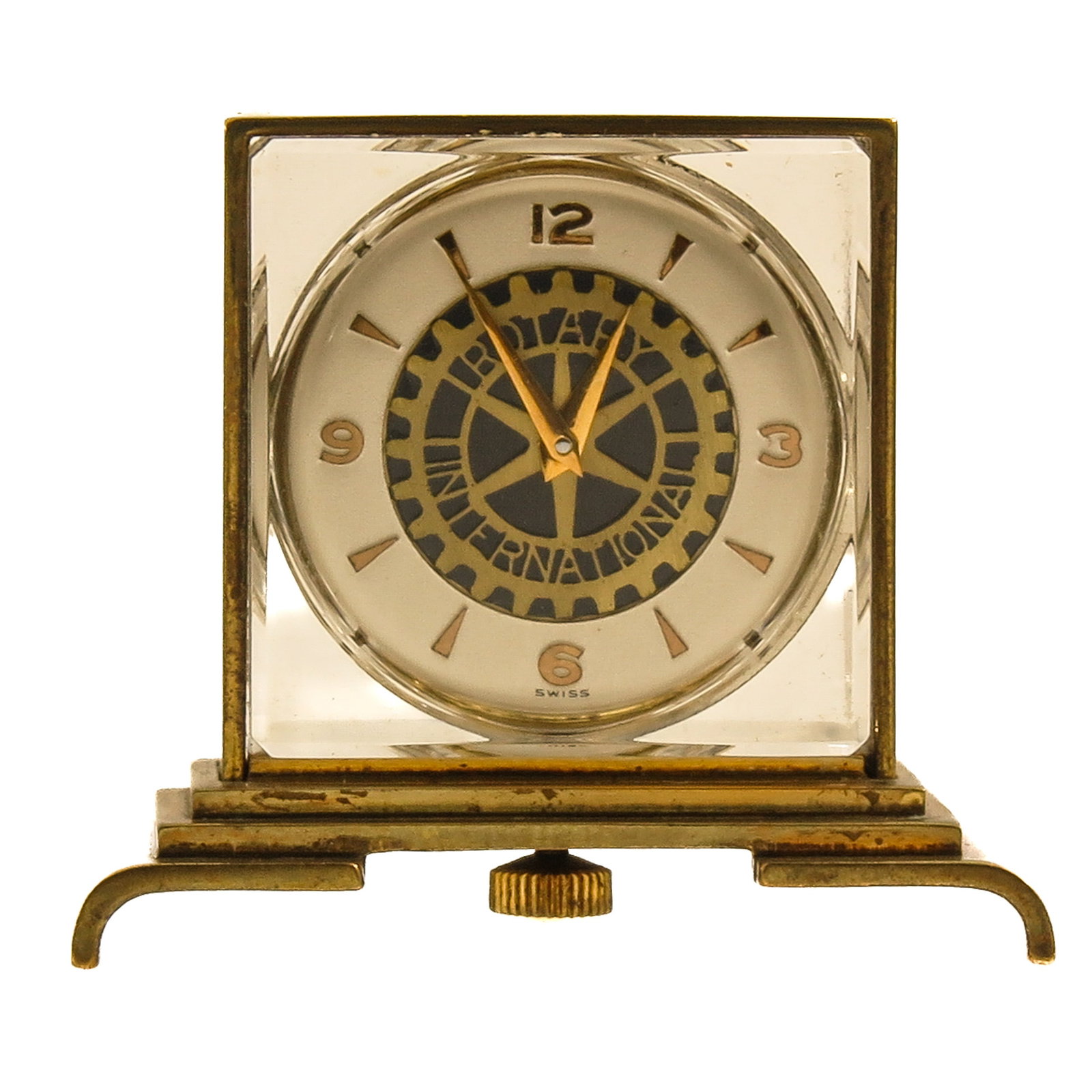 A Desk Clock: Rotary International, with glass case and brass mount, Swiss, height 4 cm.