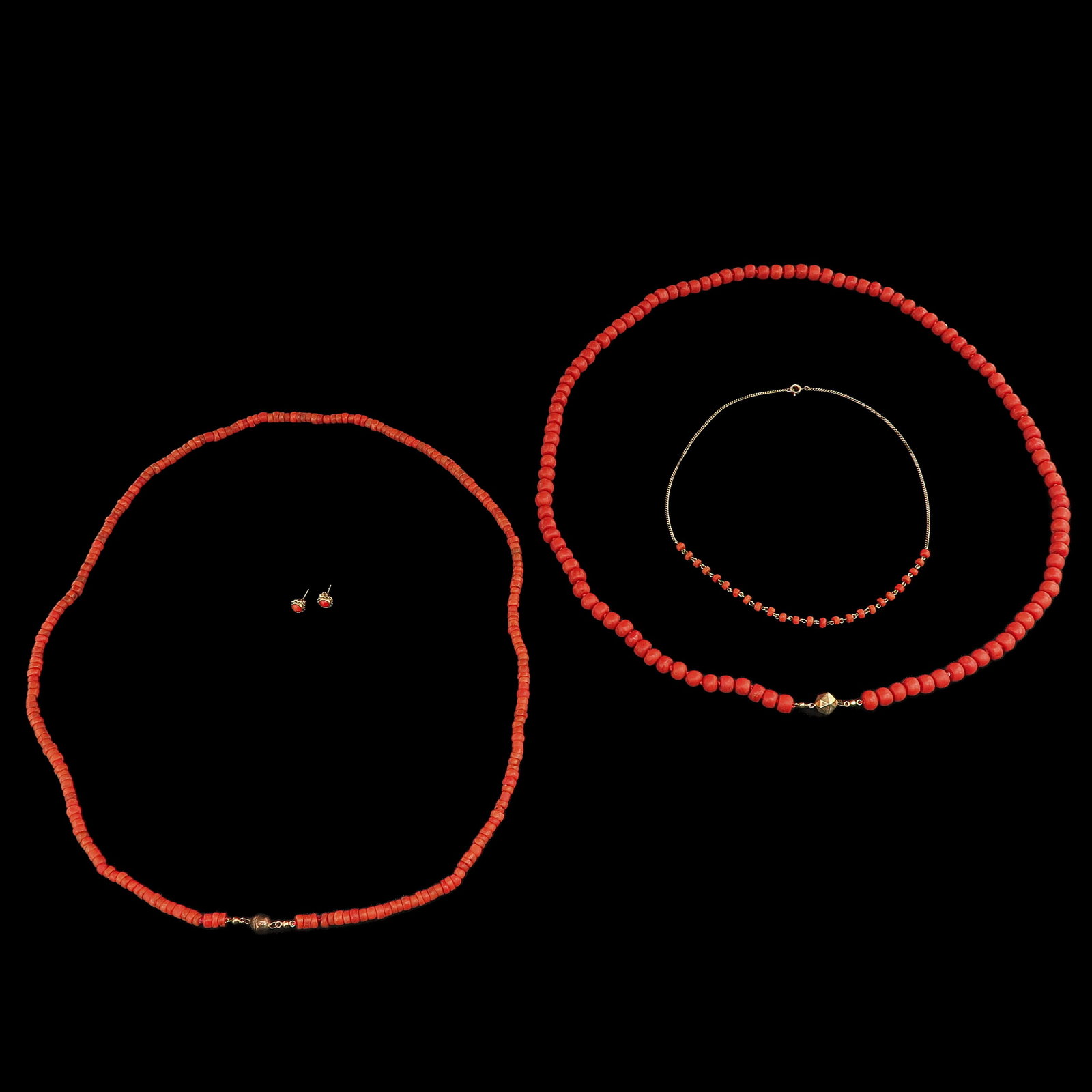 A Collection of Red Coral Jewelry: consisting of 3 necklaces and a pair of ear studs, largest beads 9 mm., total weight 123 grams
