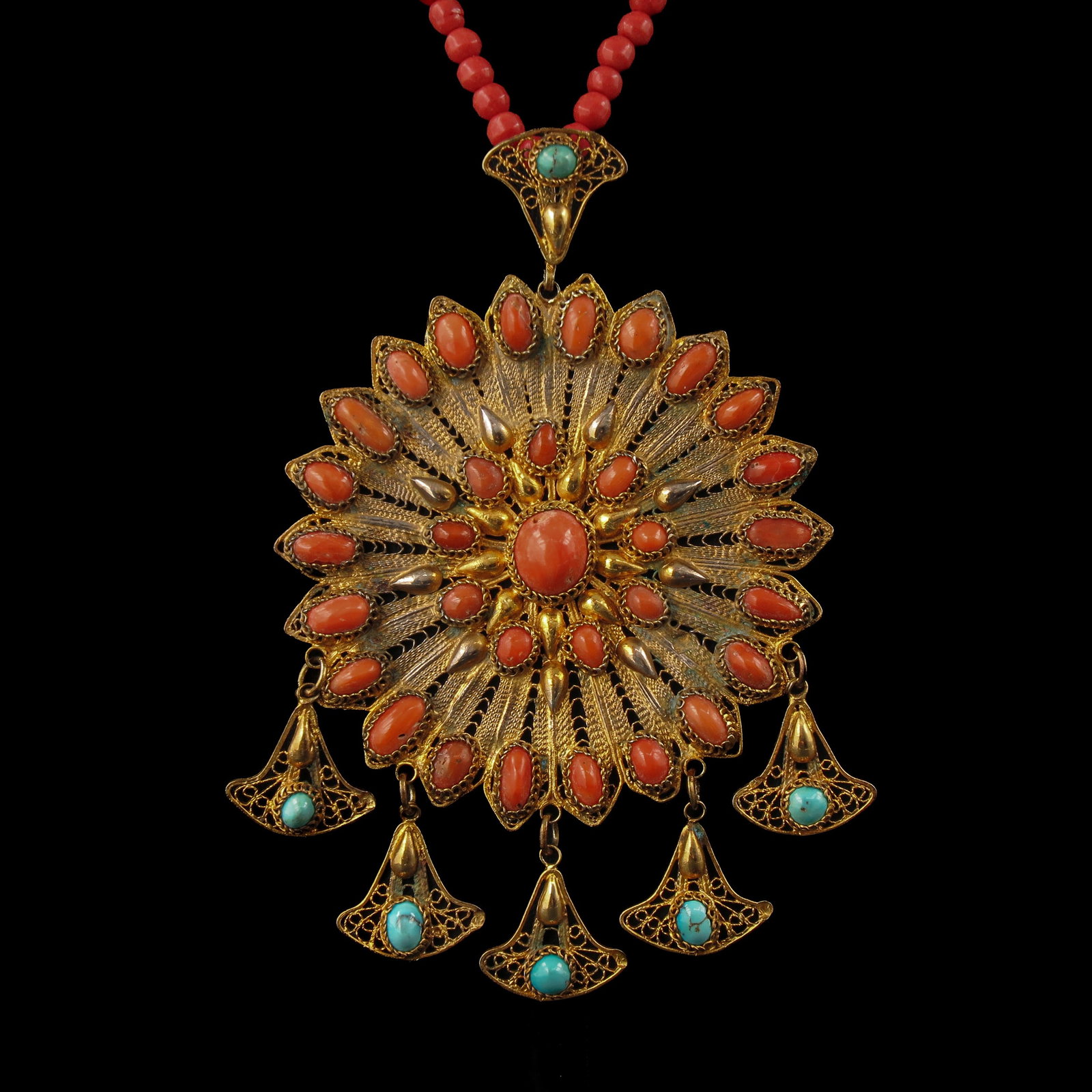 A Red Coral Necklace: with pendant set with red coral and turquoise, diameter pendant 75 mm.