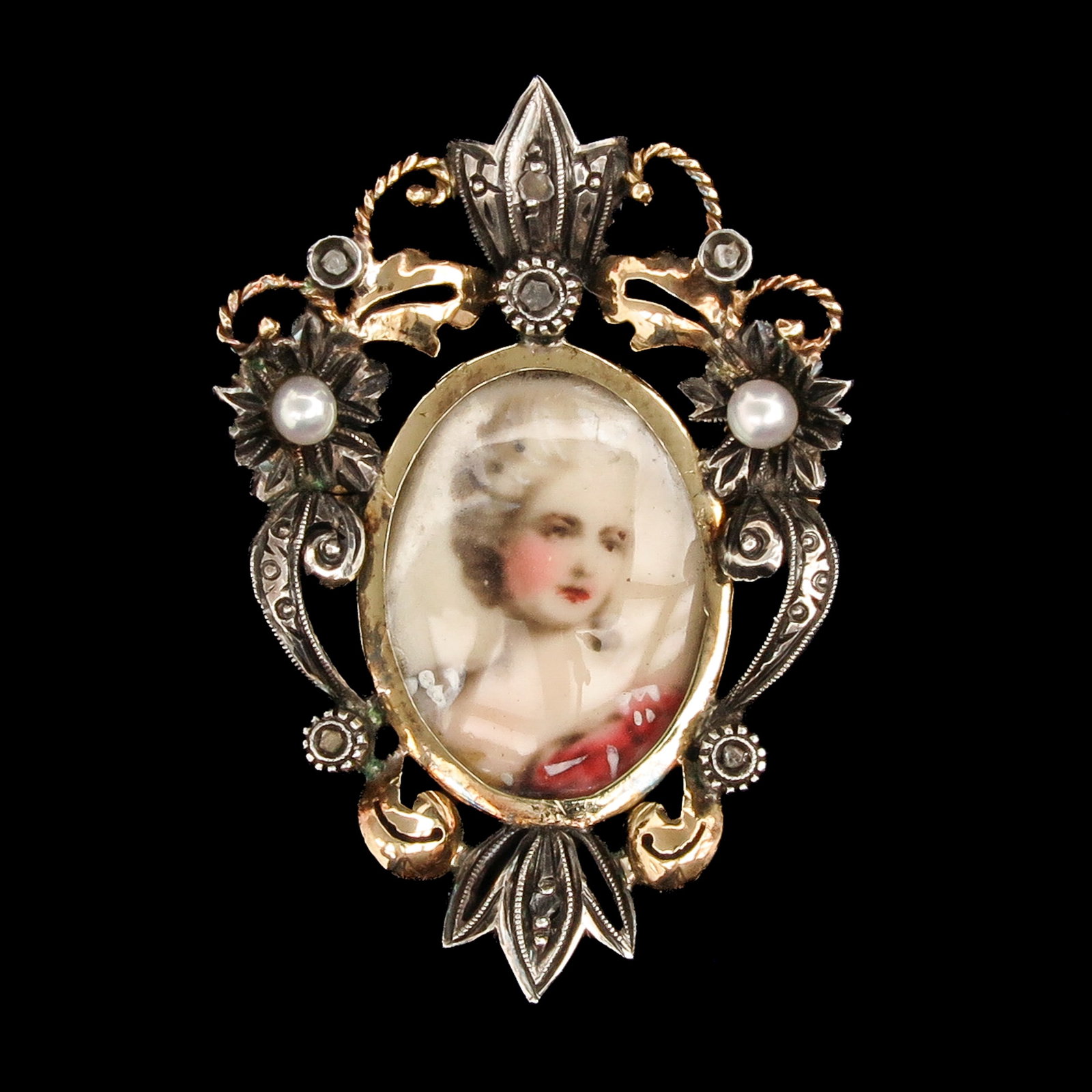 A 14KG Pendant: 14 Krt. gold on silver, set with a portrait and pearls, length 40 mm.