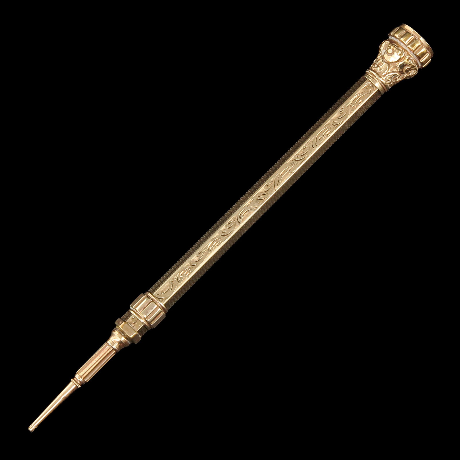 A Gold Pin: gold, with engraved floral decoration and set with carnelian, length 9,5 cm.